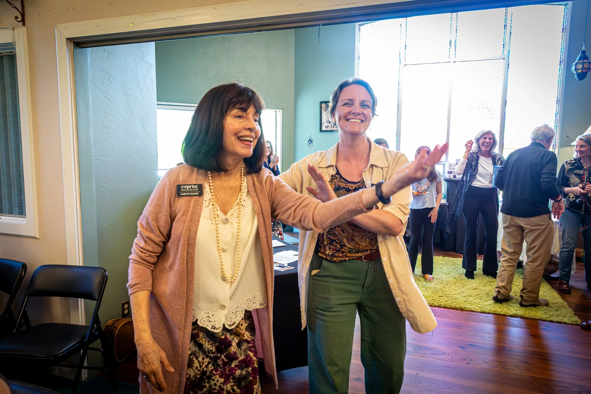  Boardmember, Marilyn McAvoy Bergman, and Co-founder/Vice President, Alexis Lewis welcome guests to a fundraiser concert.  Photo by RyLo Media Design 