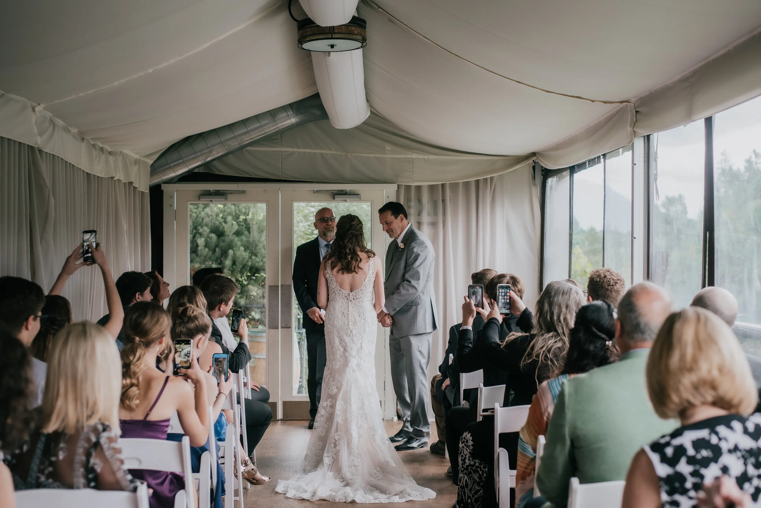 this was a very intimate venue where i could only shoot from behind and in the aisle. no way to avoid long shots of the ceremony without getting a sea of phones in the air.