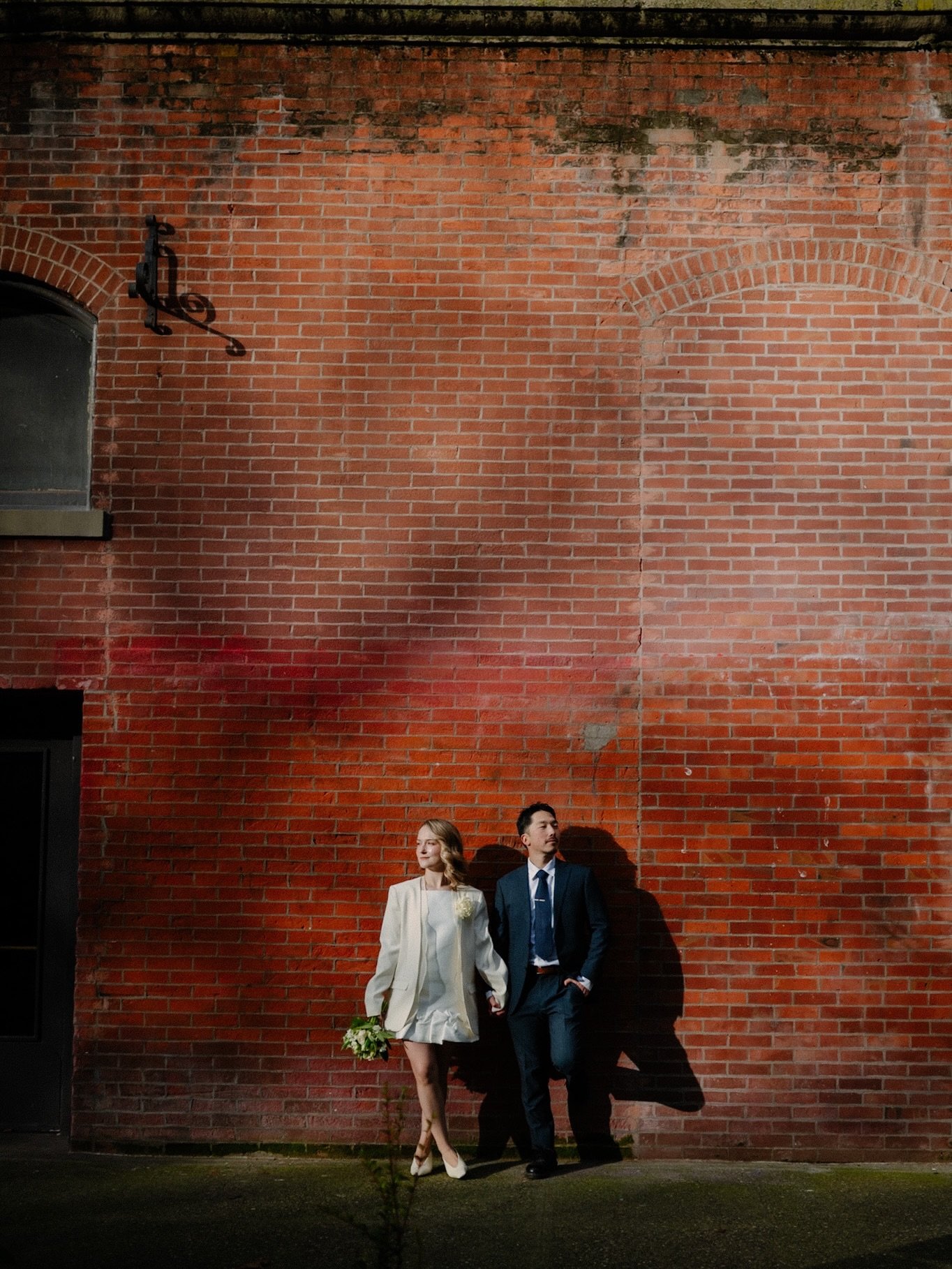pre courthouse elopement portraits &amp; that winter light in pioneer square seattle. ✨

that low seattle sun cutting across the brick, long shadows wrapping around them, and a quiet walk before everything officially begins. just the two of them hand