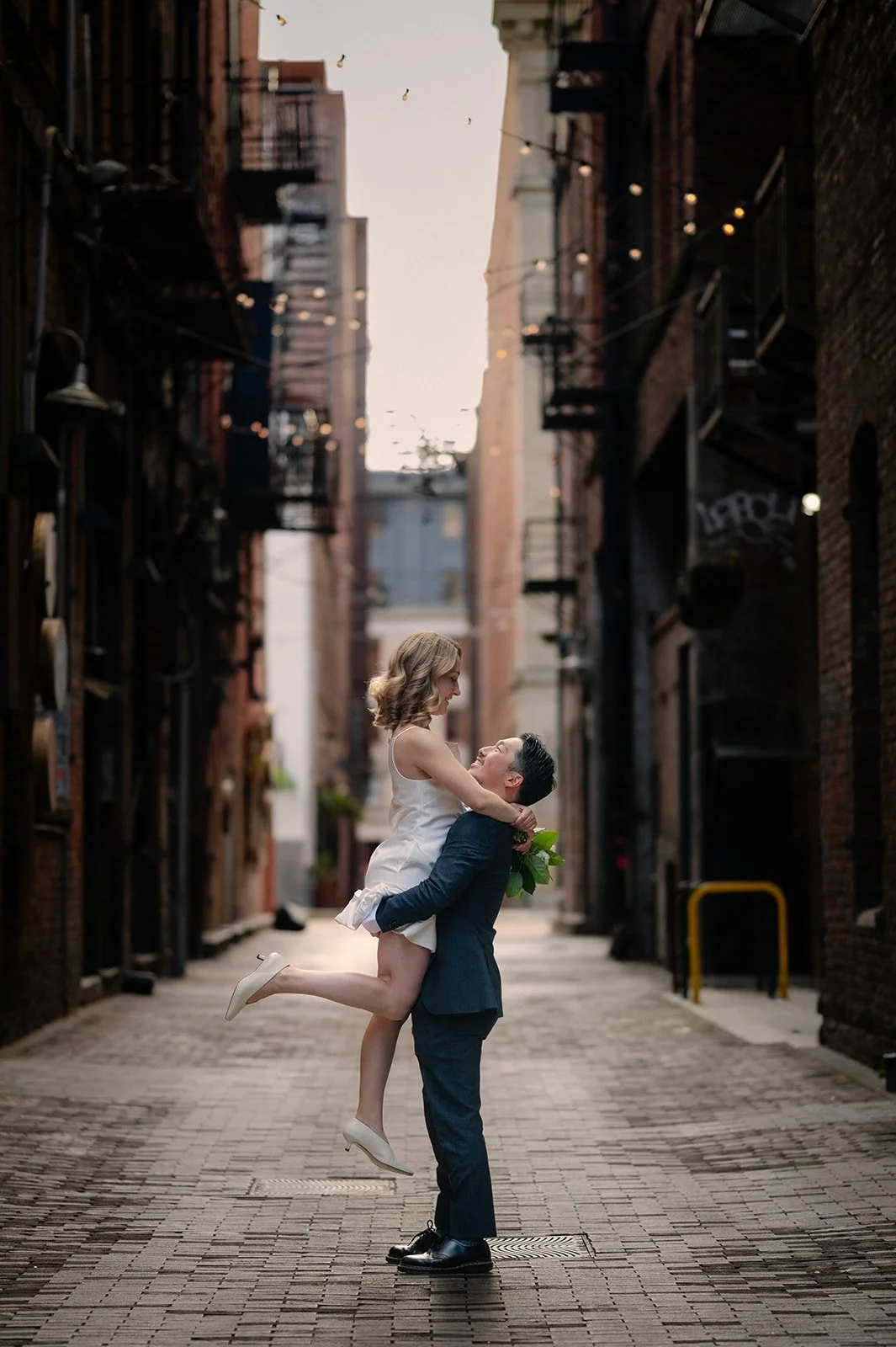 playful bride and groom at the pioneer square during their elopement day in seattle