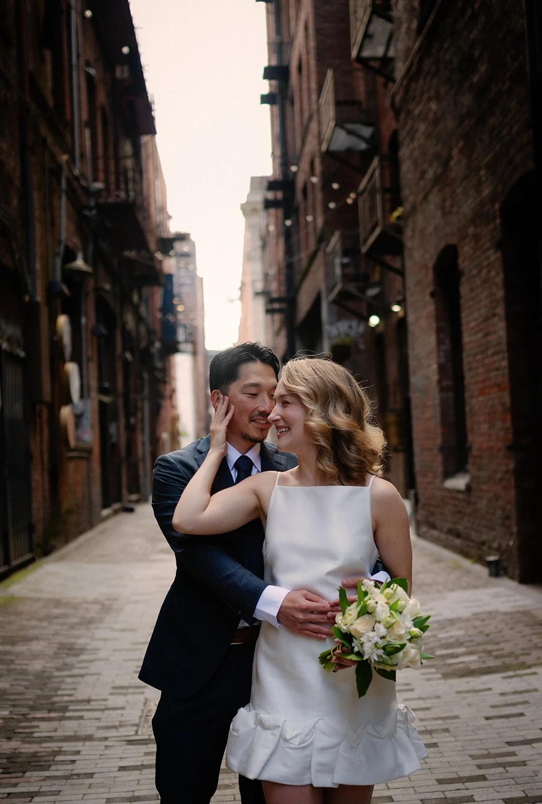 playful bride and groom at the pioneer square during their elopement day in seattle