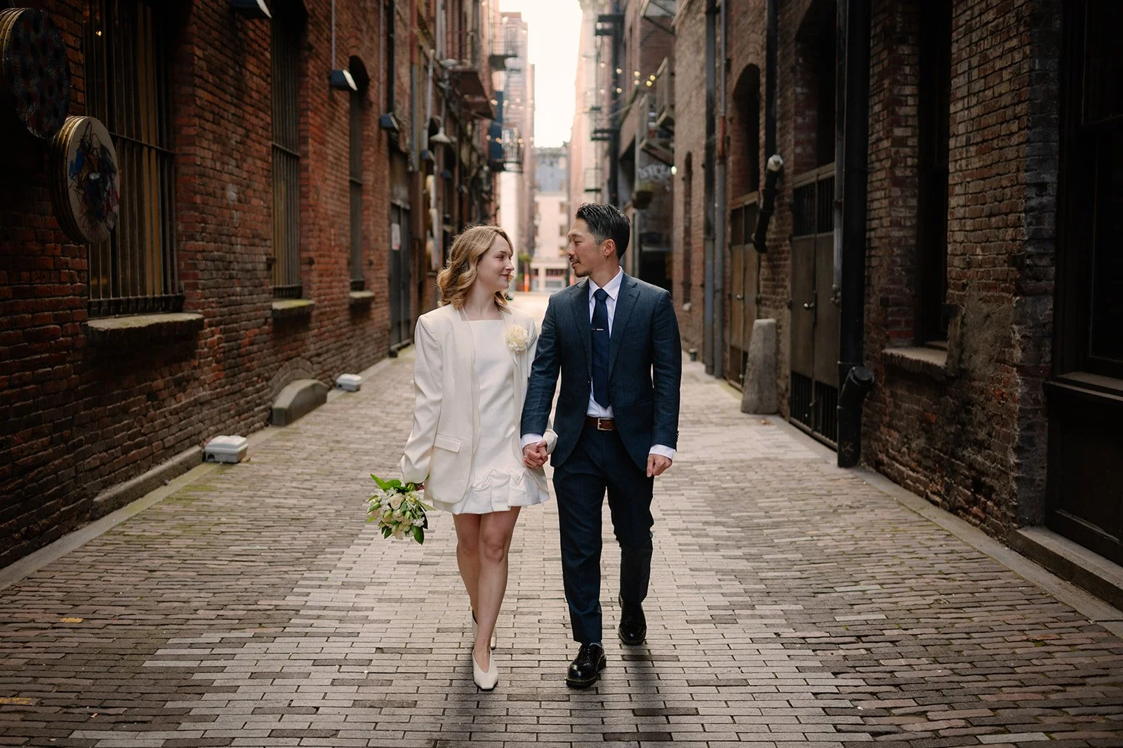 playful bride and groom at the pioneer square during their elopement day in seattle