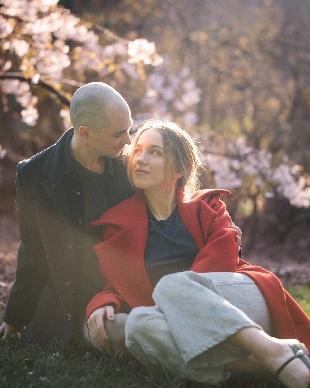 🍒cherry blossoms at peak bloom, golden light going soft through the branches, a red coat against the green. 

washington park arboretum engagement photos in april are something special. this is seattle spring engagement photography at its quietest a