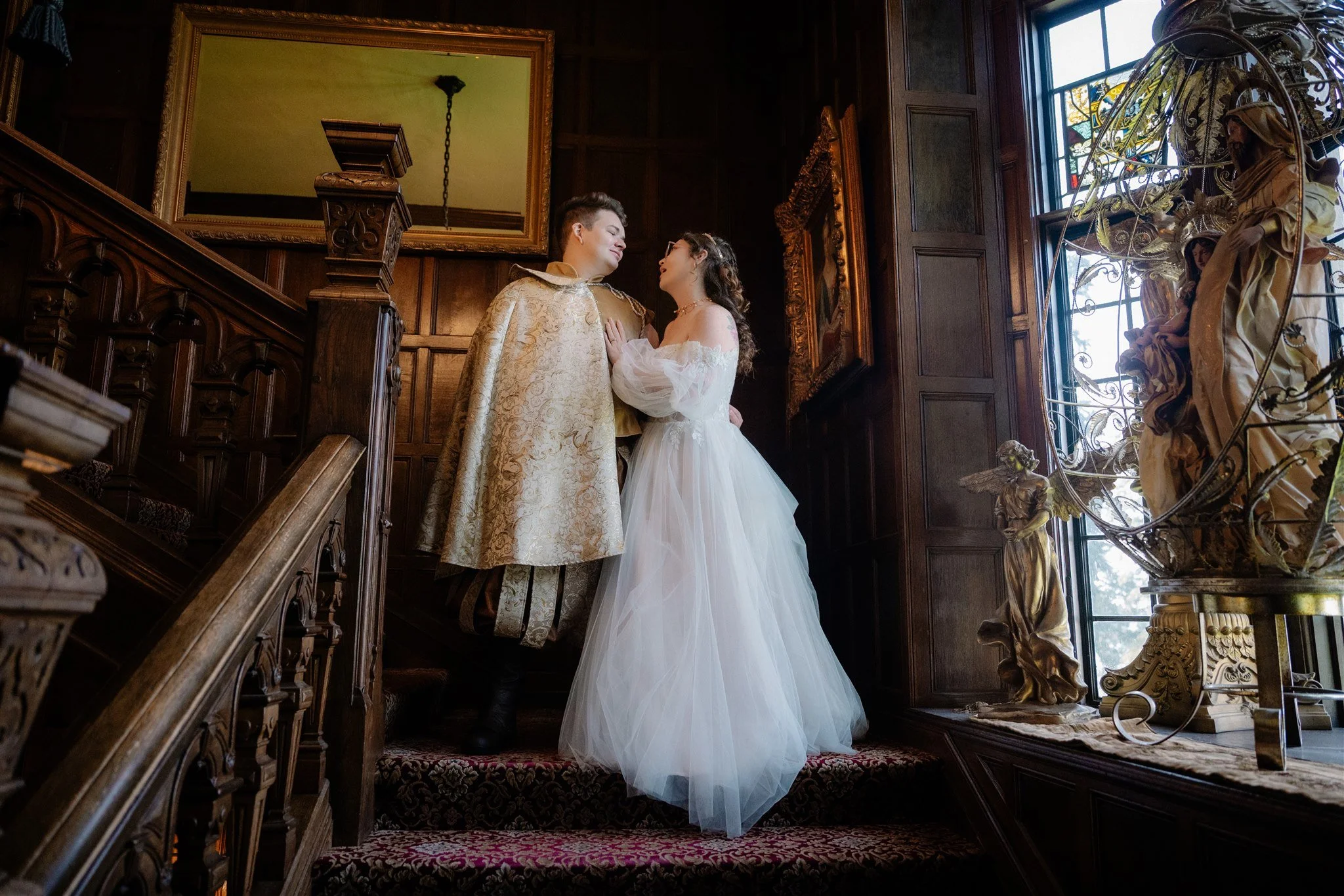 bride and groom posing on the steps at thornewood castle