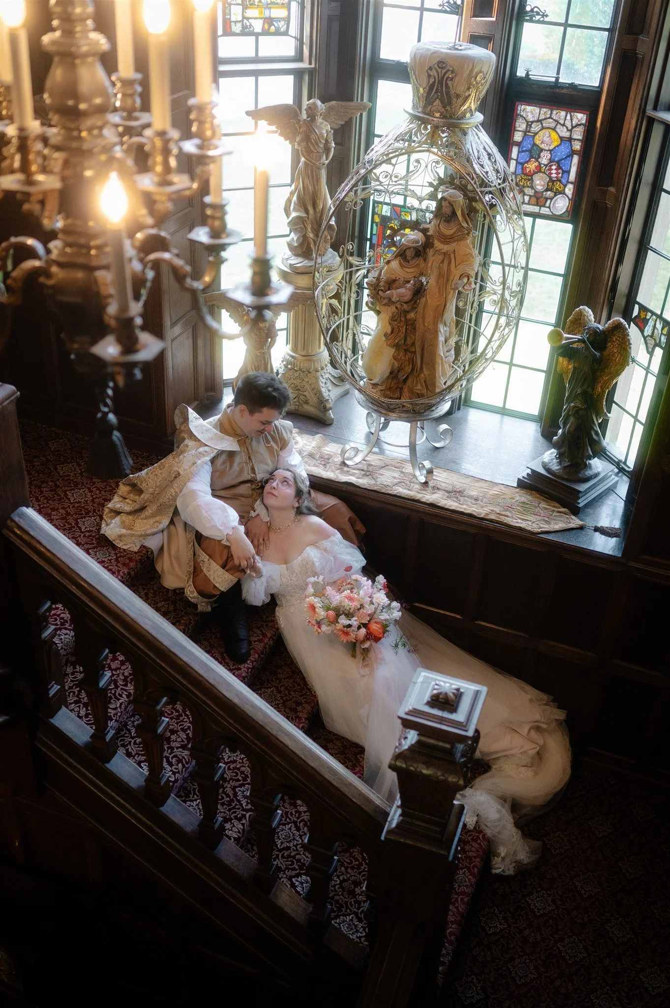 bride and groom indoors on the steps during their thornewood castle wedding