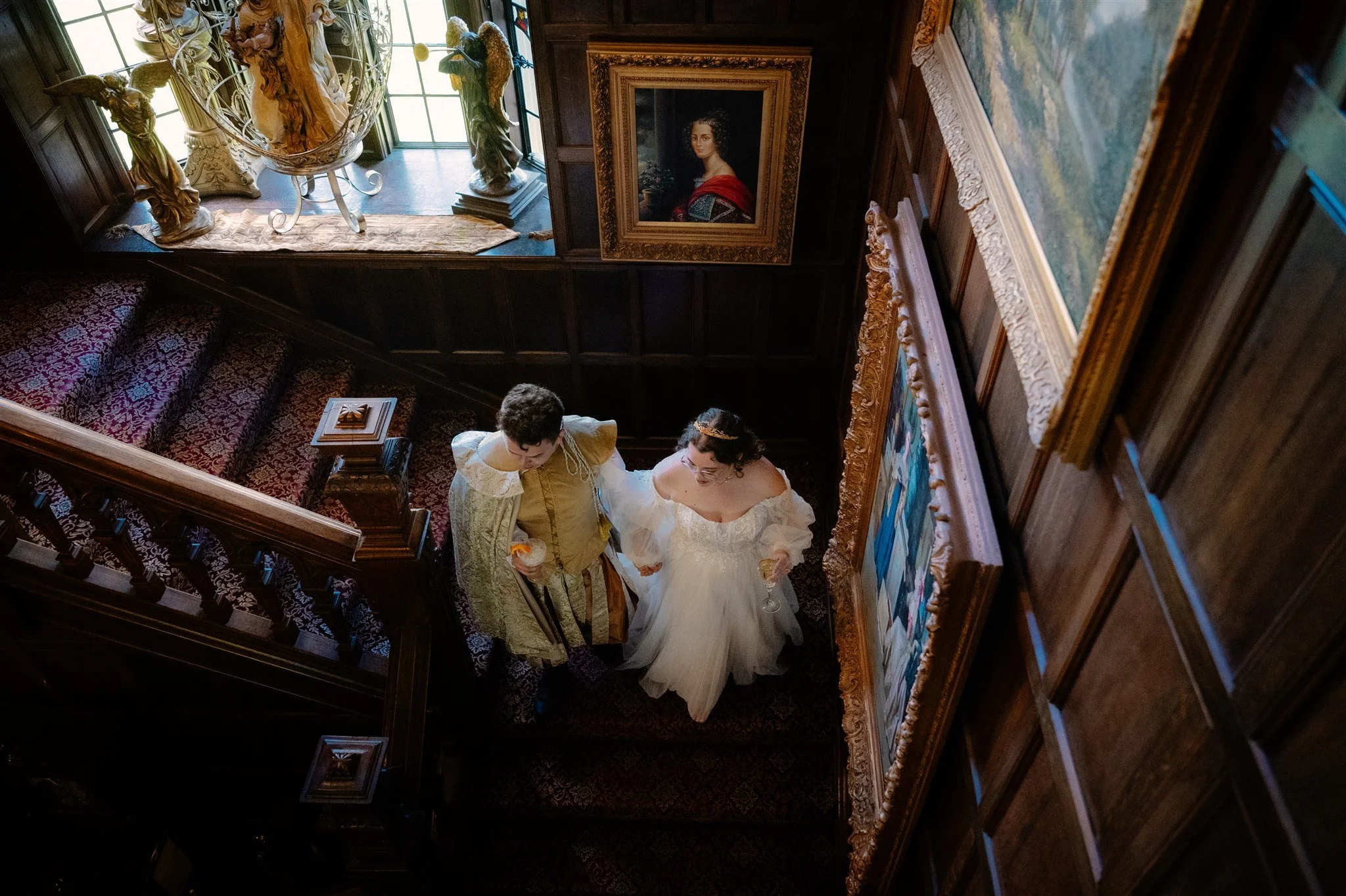 bride and groom indoors on the steps during their thornewood castle wedding