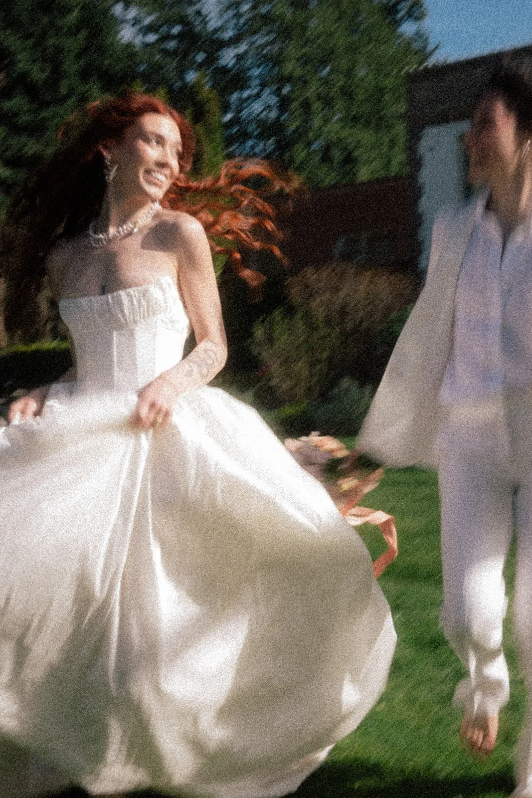 queer wedding couple running around the lush grounds during their lairmont manor wedding