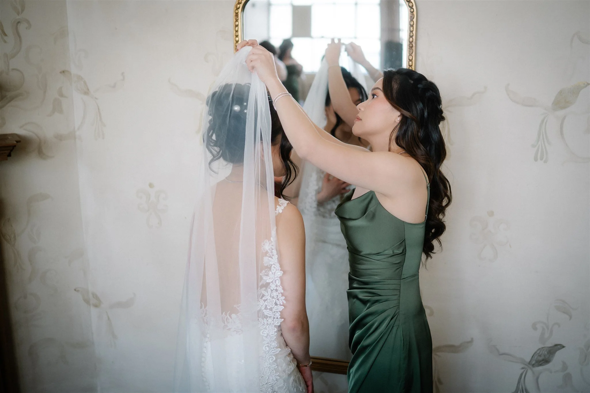 bridesmaid helping bride with the veil