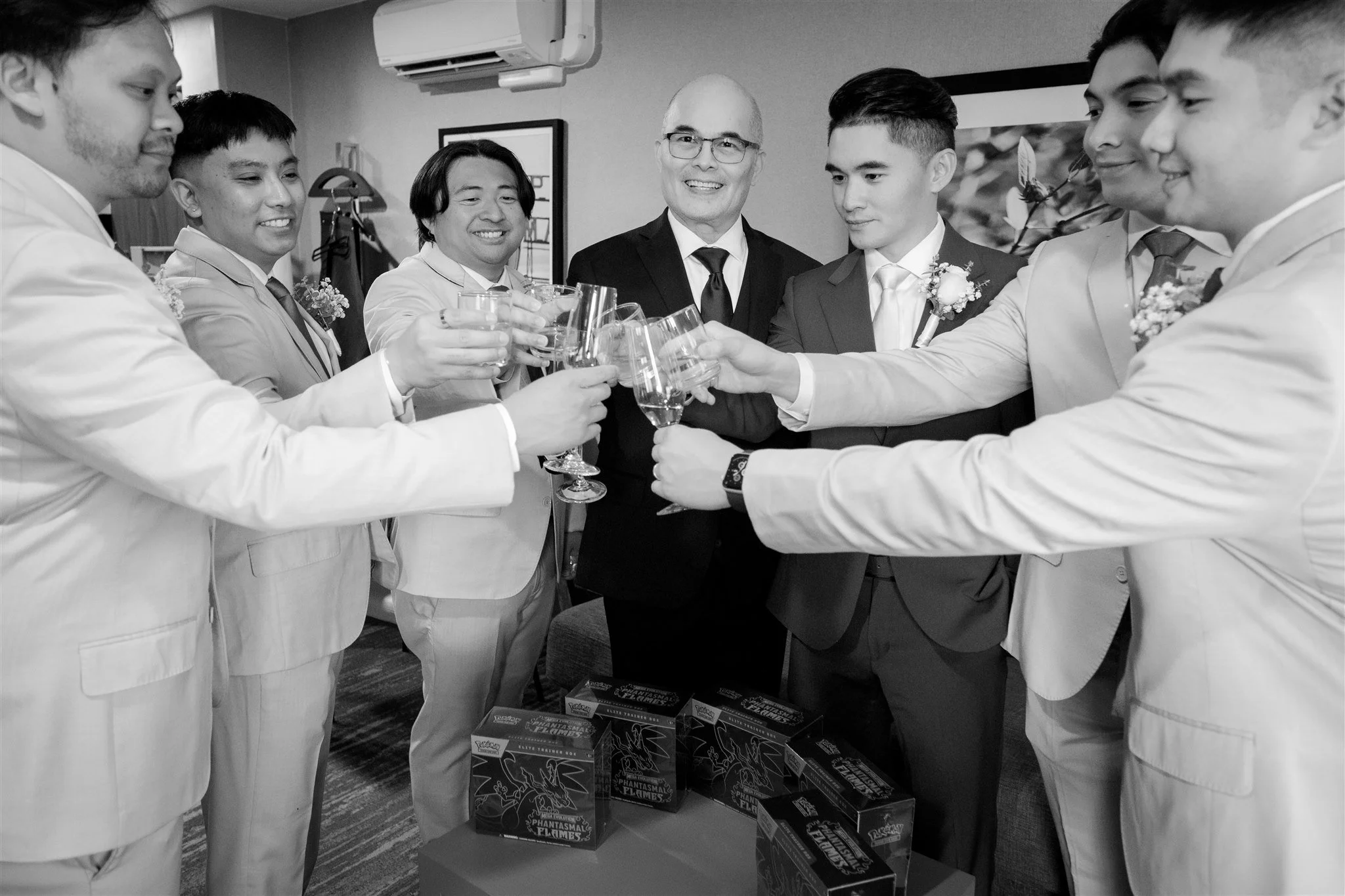 groom and groomsmen enjoying drinks while getting ready