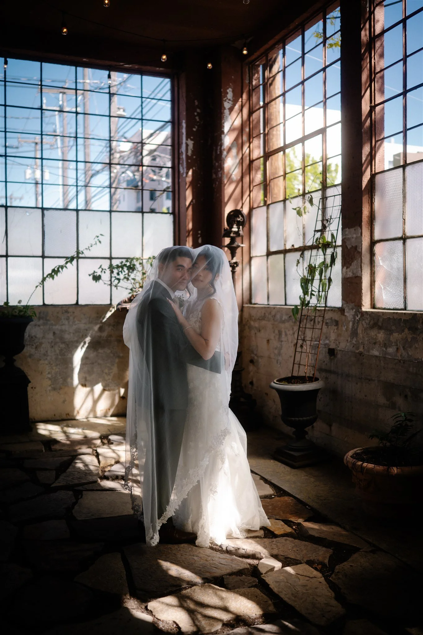 Romantic couple portraits at The Ruins Seattle wedding venue with moody light and greenery