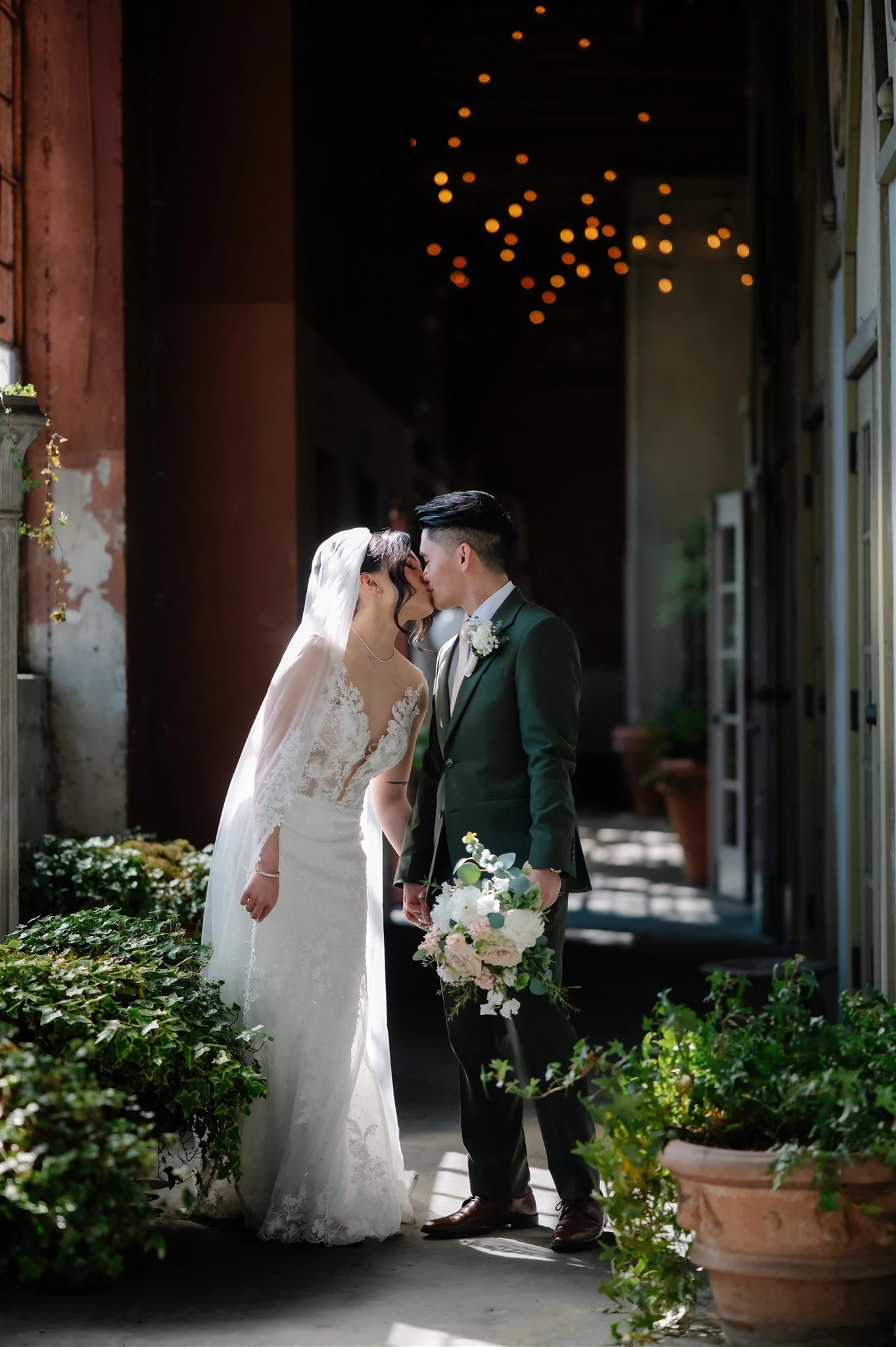 Romantic couple portraits at The Ruins Seattle wedding venue with moody light and greenery