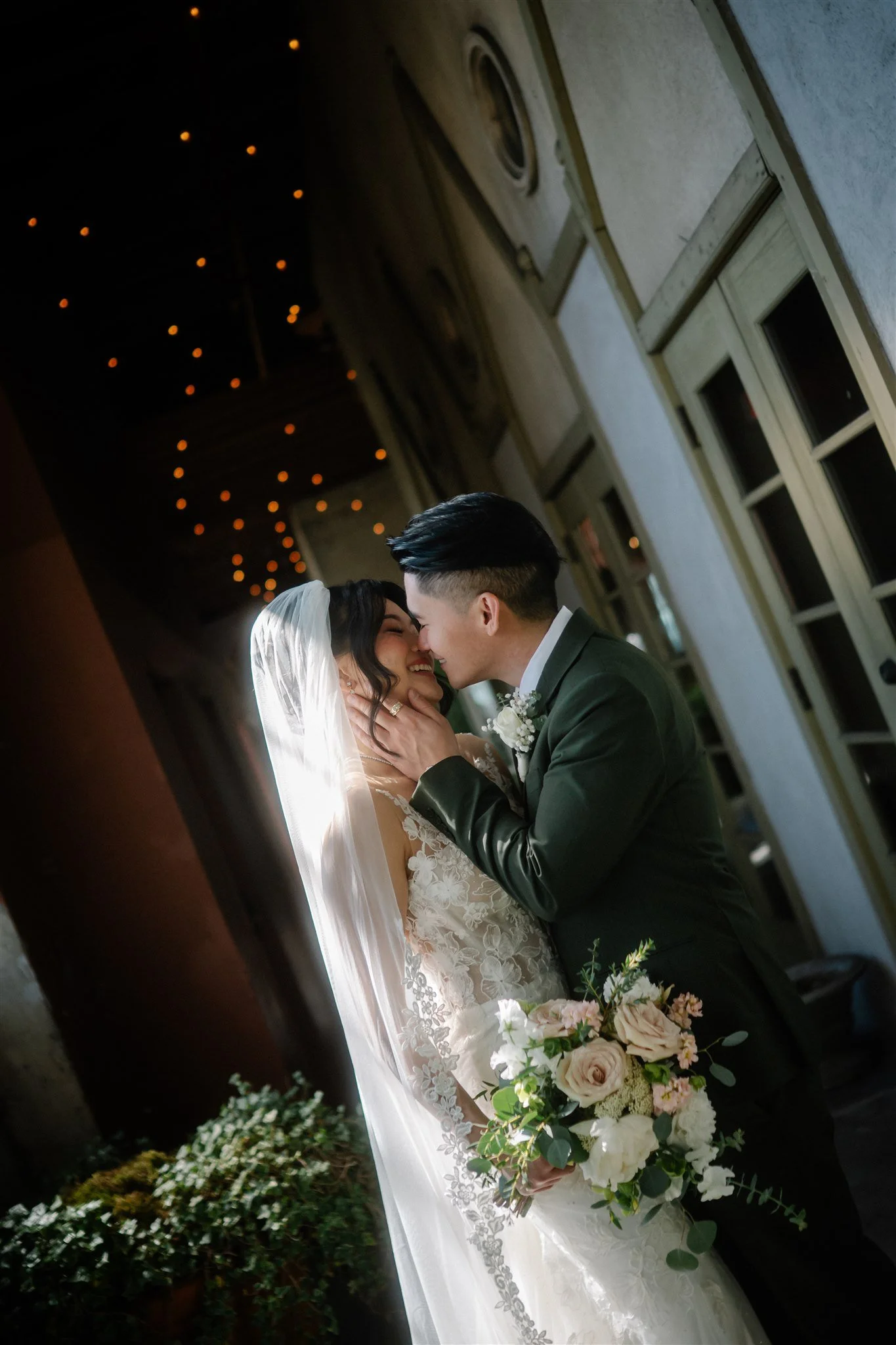 Romantic couple portraits at The Ruins Seattle wedding venue with moody light and greenery