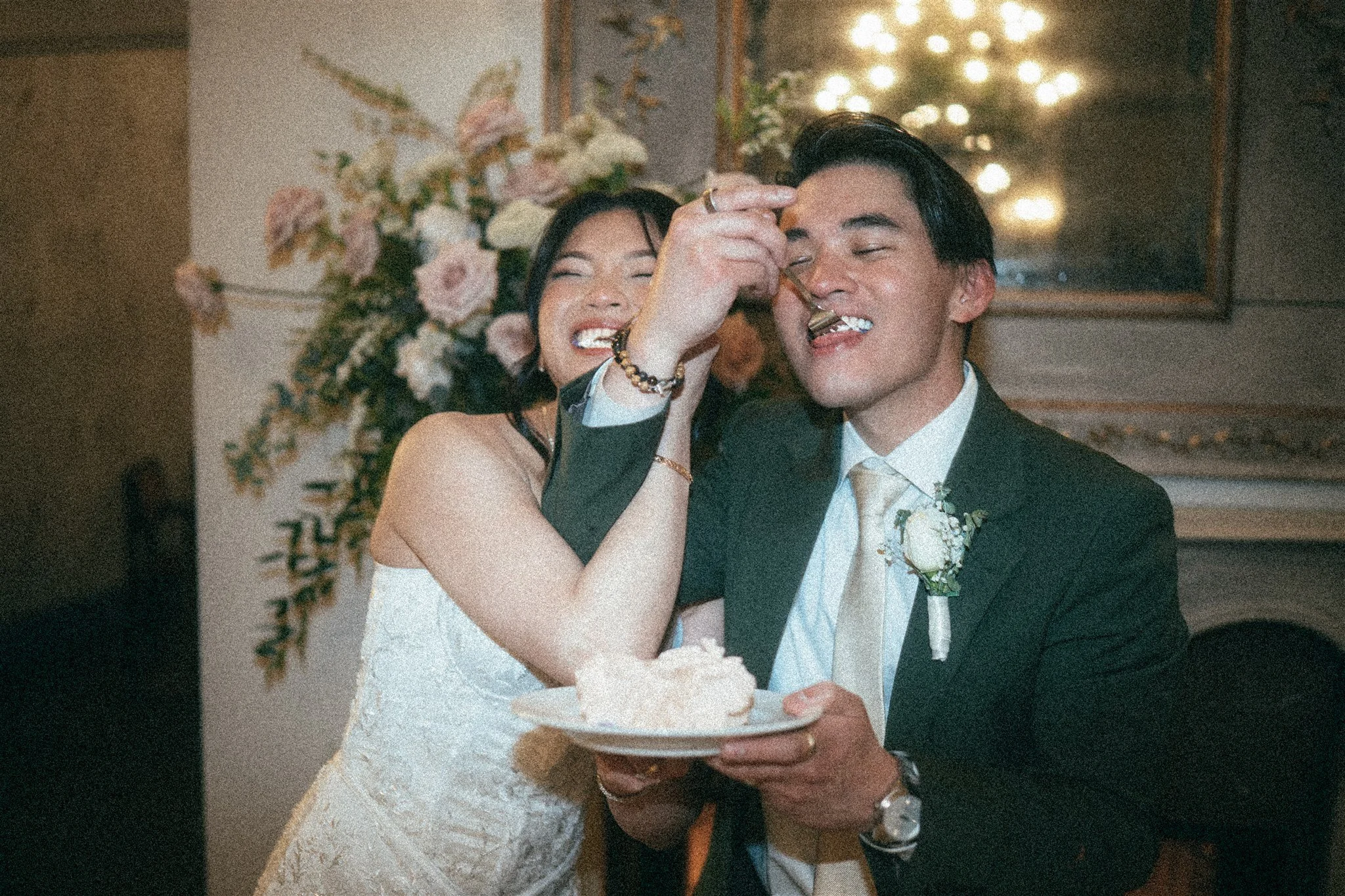 bride and groom cutting cake during their wedding reception at the ruins in seattle