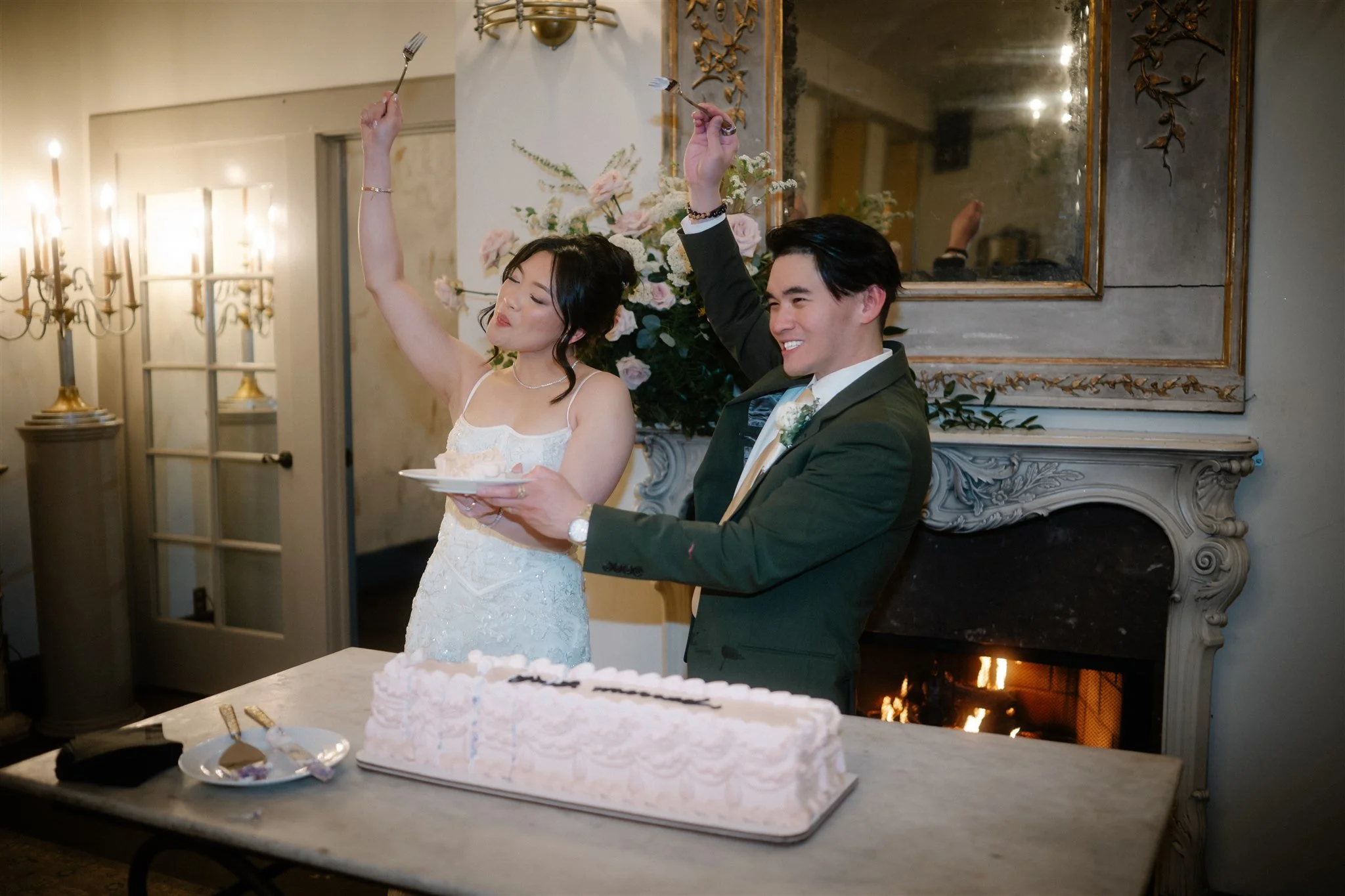 bride and groom cutting cake during their wedding reception at the ruins in seattle