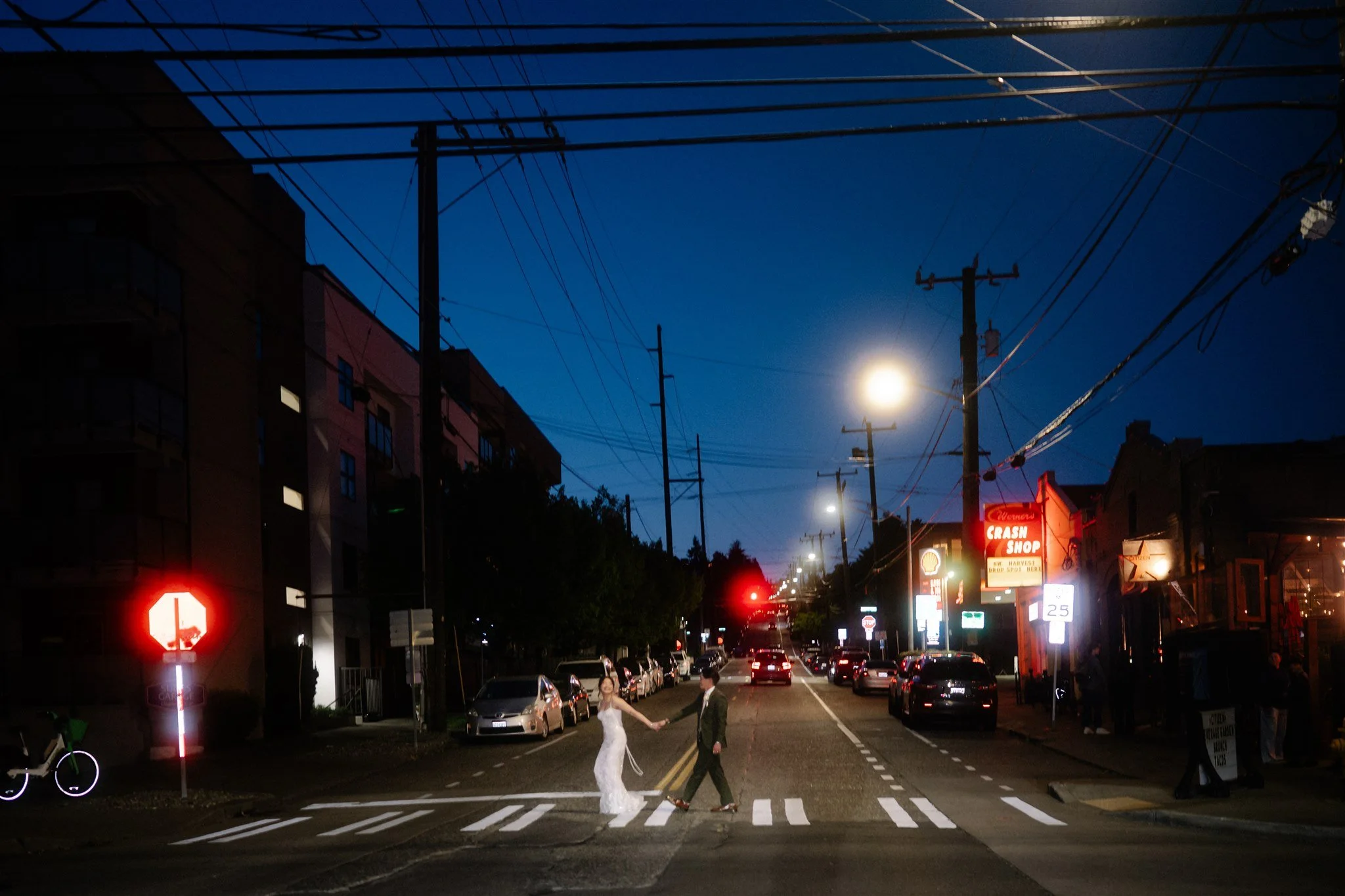 Romantic night wedding photos crossing the street in Seattle