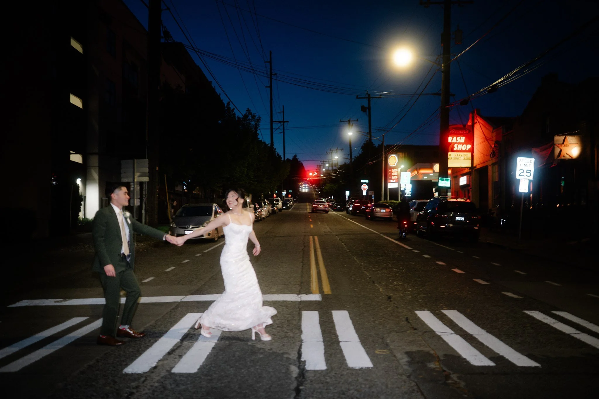 Romantic night wedding photos crossing the street in Seattle