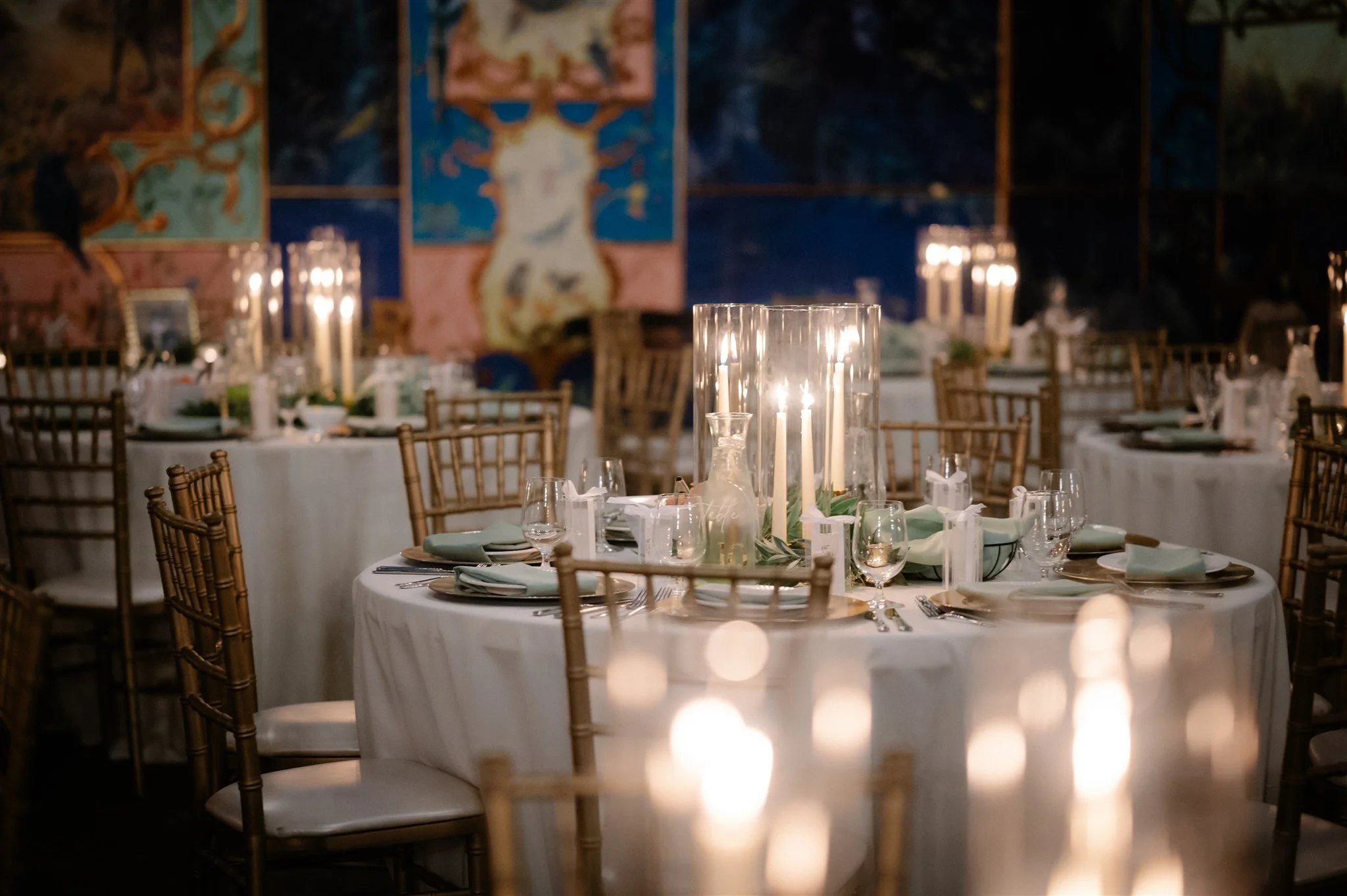 Luxury Seattle wedding reception with tall candles and gold chairs