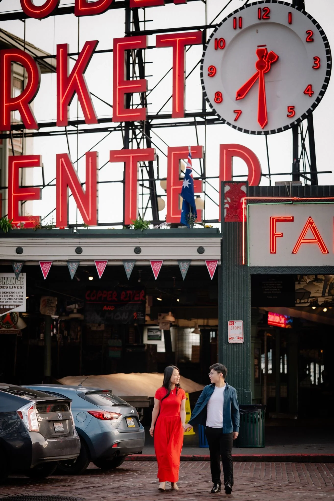 asian couple during their seattle engagement at pike place market