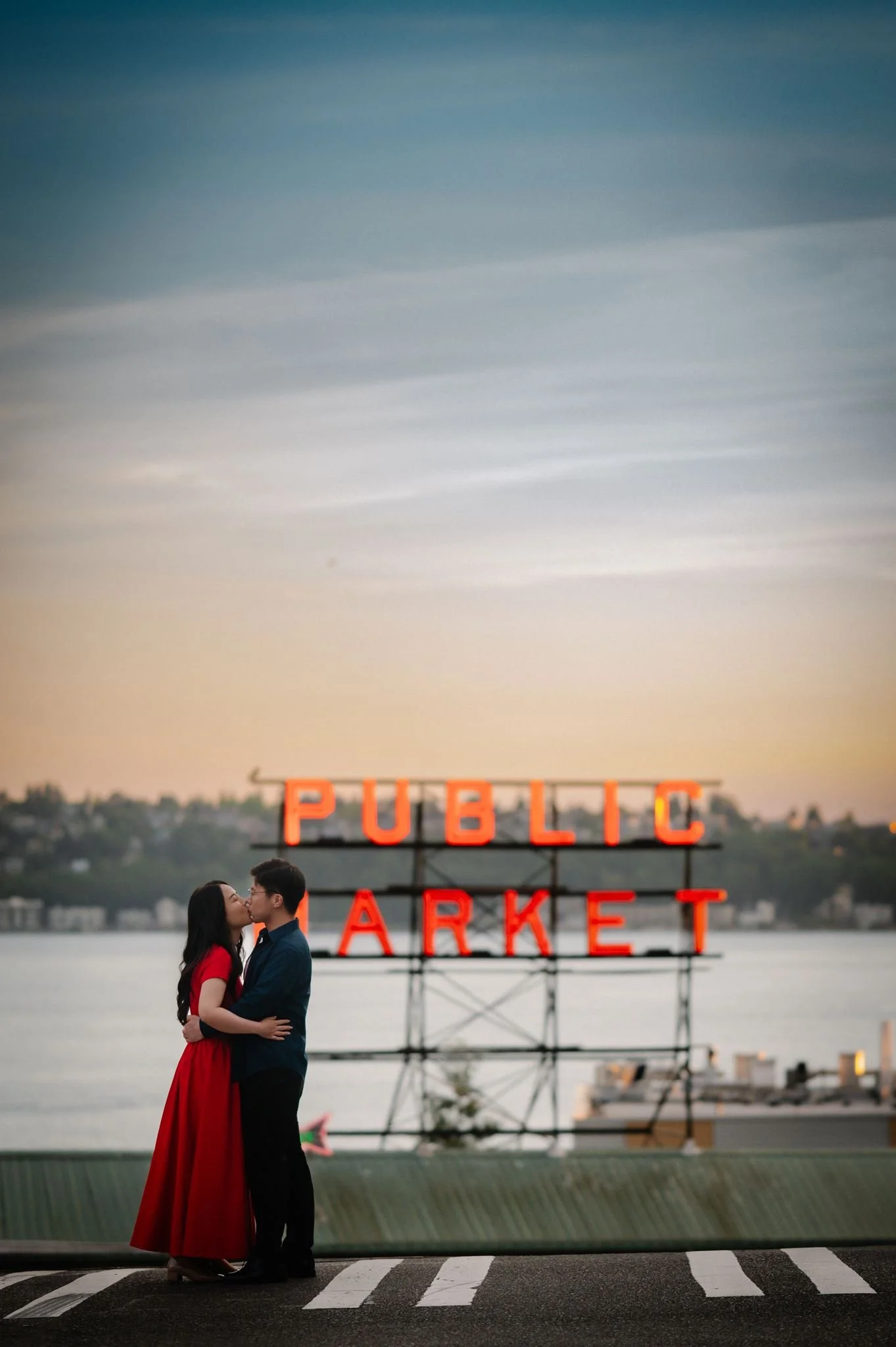 asian couple during their seattle engagement at pike place market