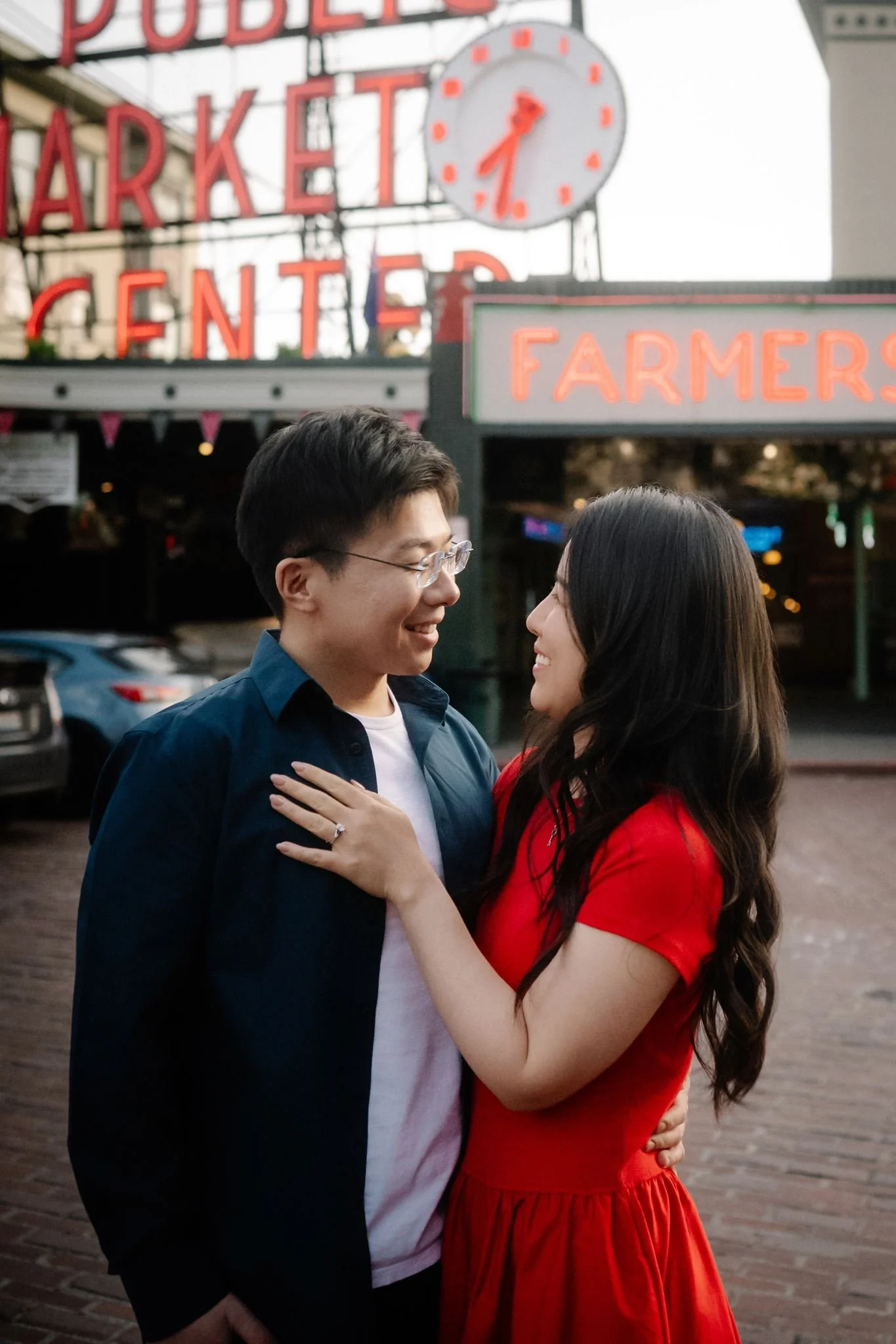 asian couple during their seattle engagement at pike place market