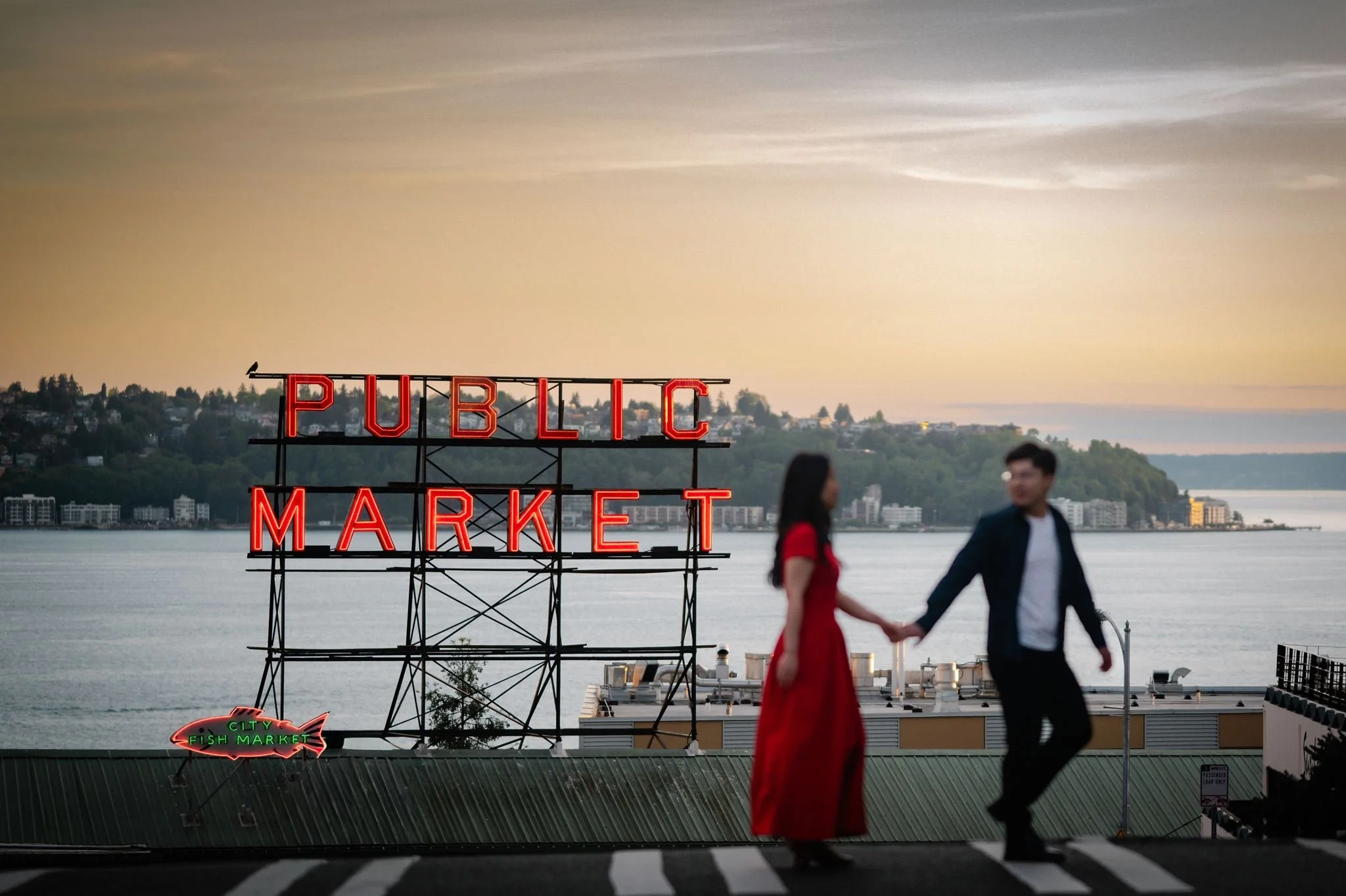 asian couple during their seattle engagement at pike place market