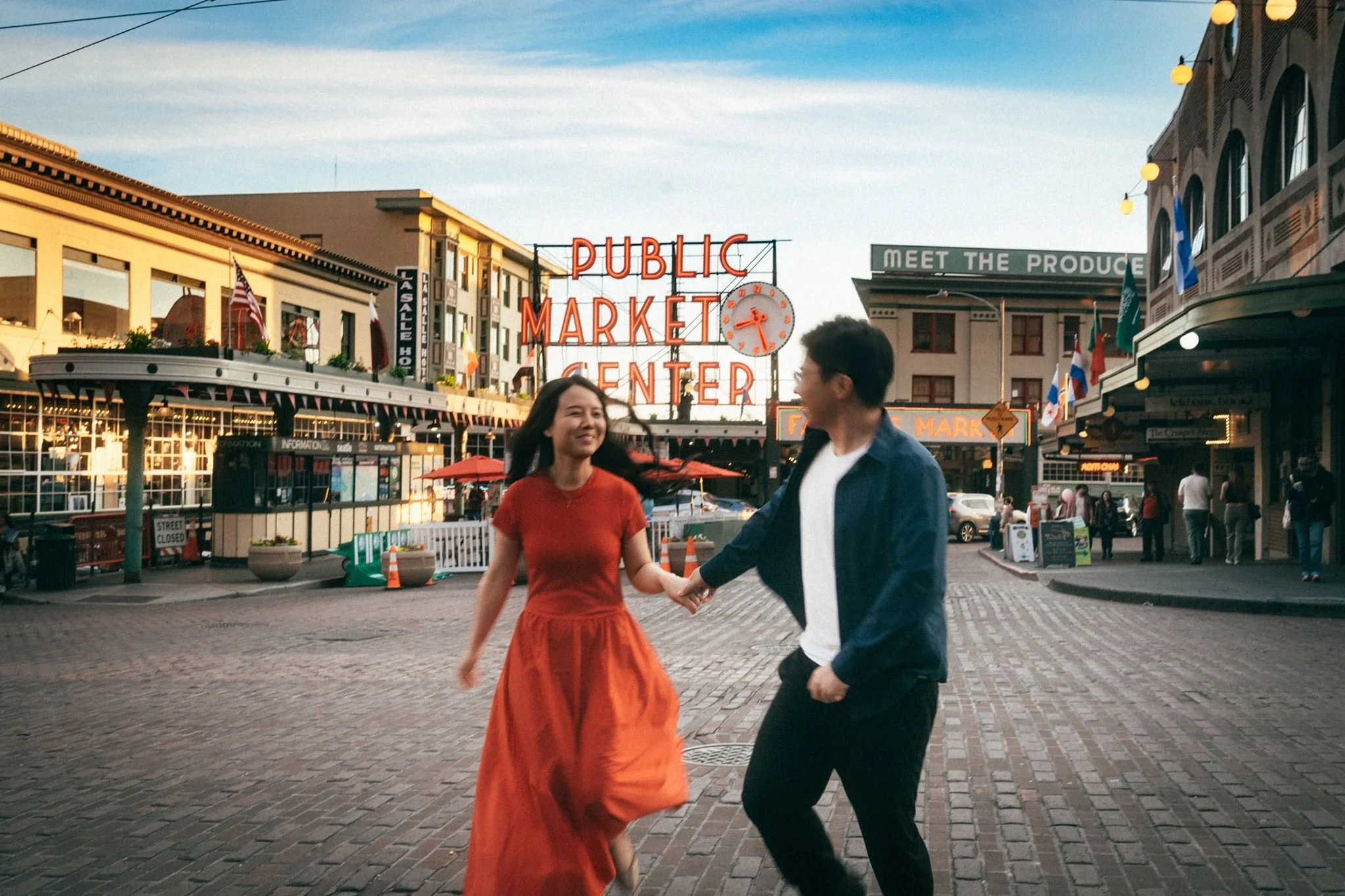 asian couple during their seattle engagement at pike place market