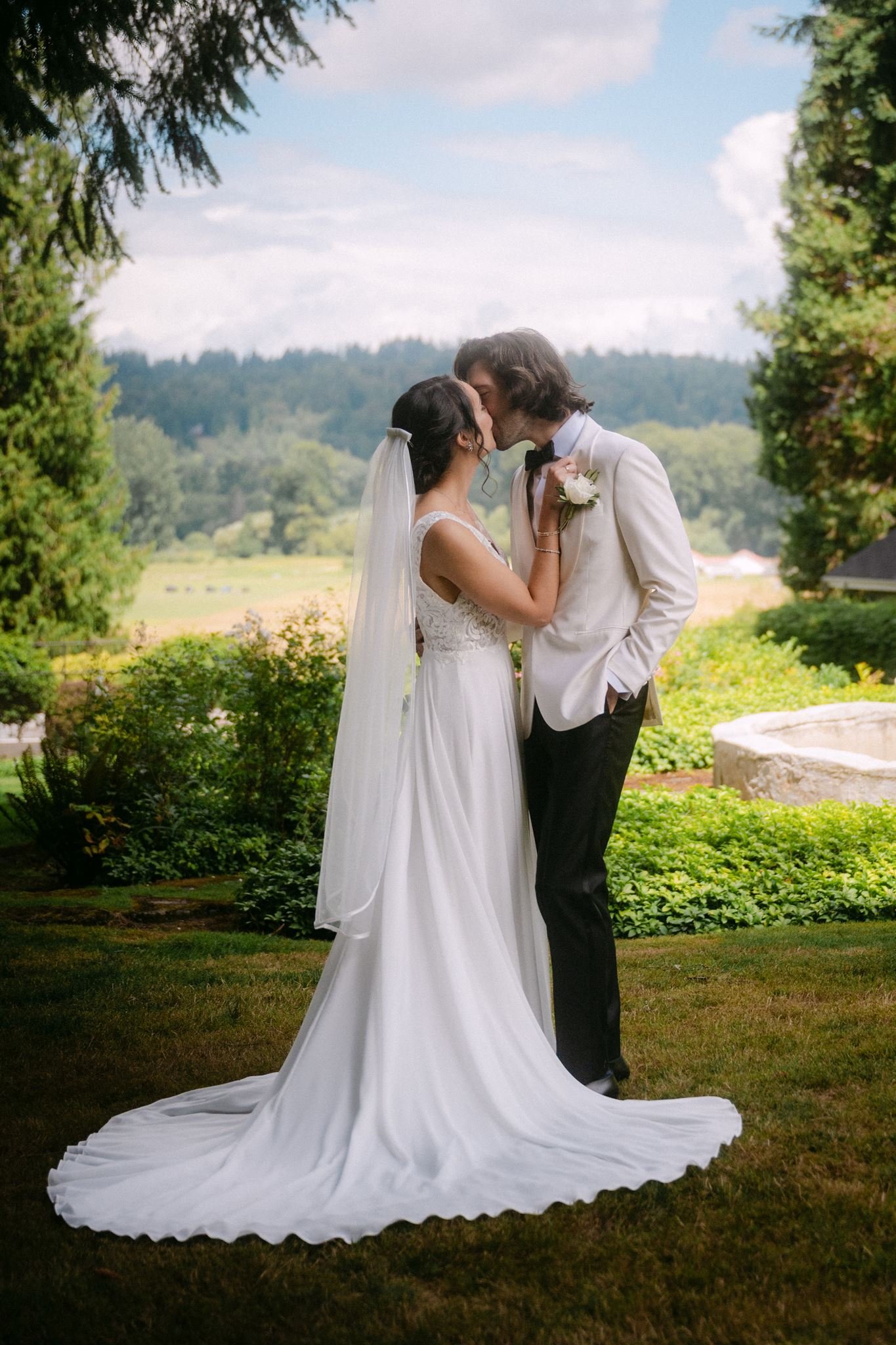 bride and groom surrounded by lush green landscapes of carnation farms wedding day