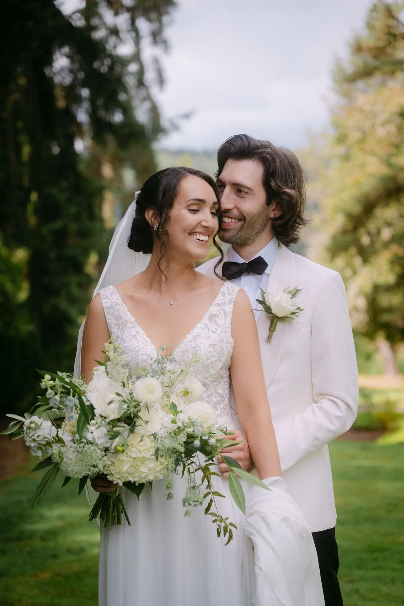 bride and groom surrounded by lush green landscapes of carnation farms wedding day