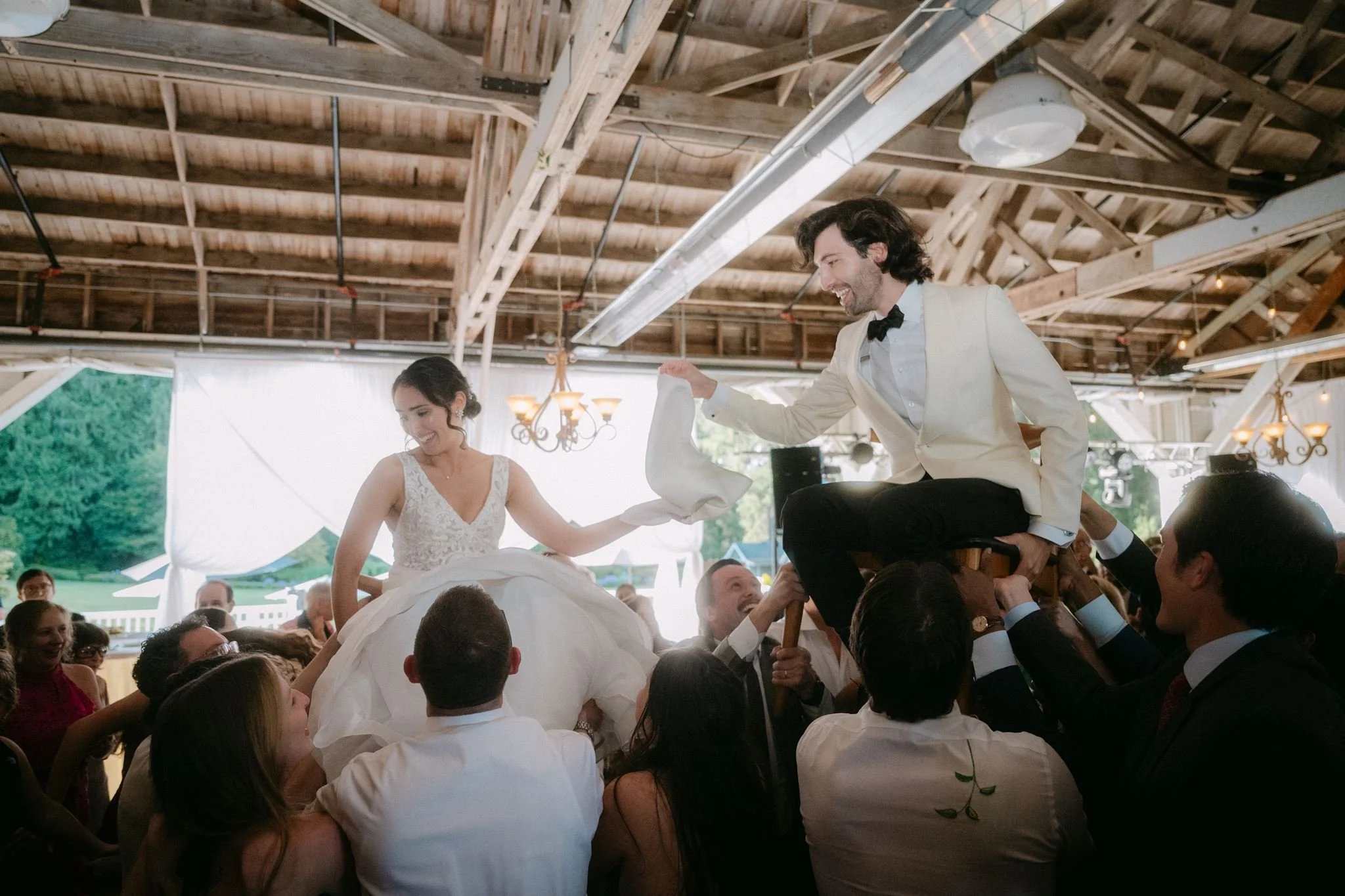 candid wedding reception moments at the rustic pavilion in carnation farms, wa