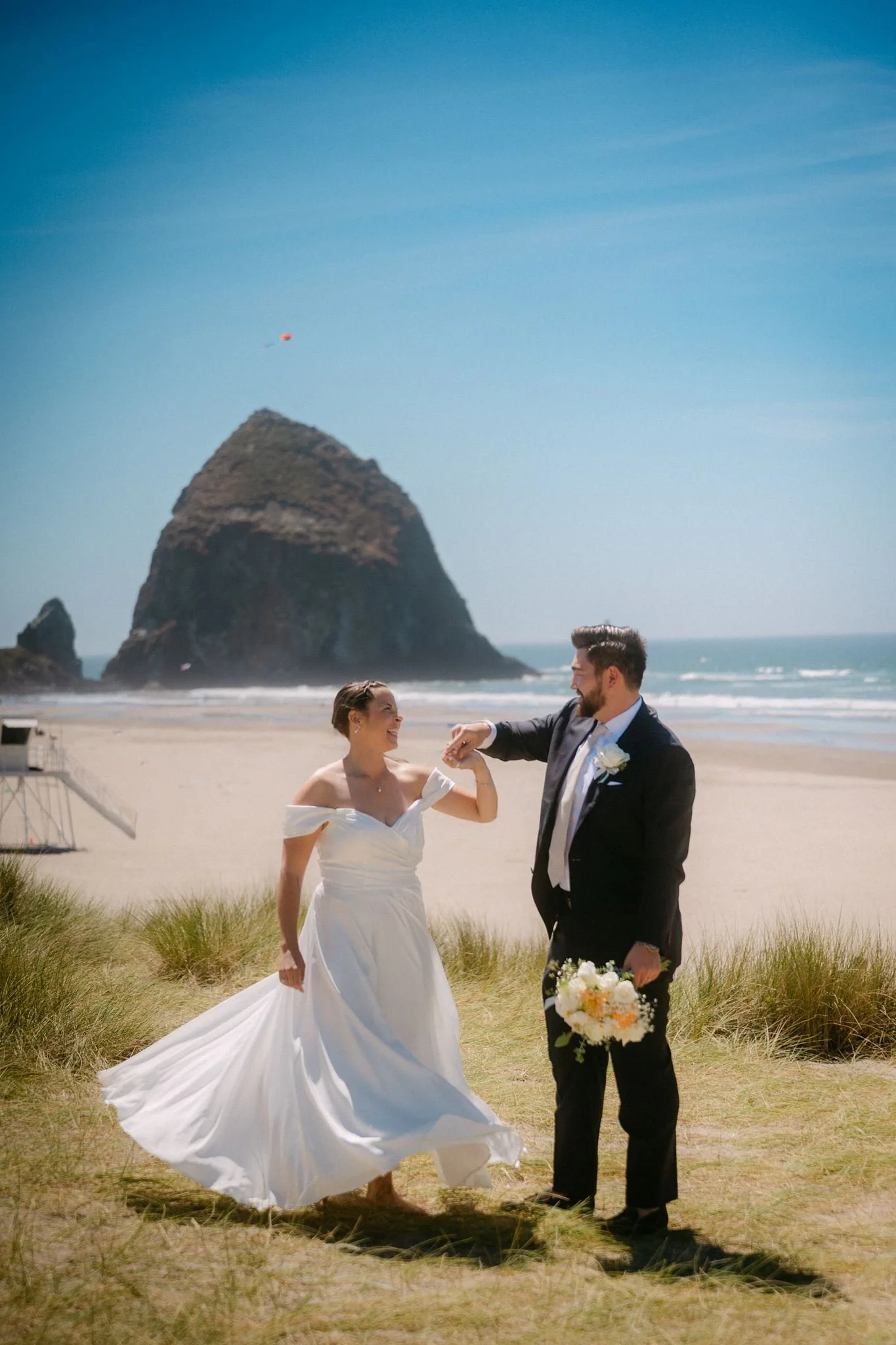bride and groom at the beach during their cannon beach wedding on the oregon coast 