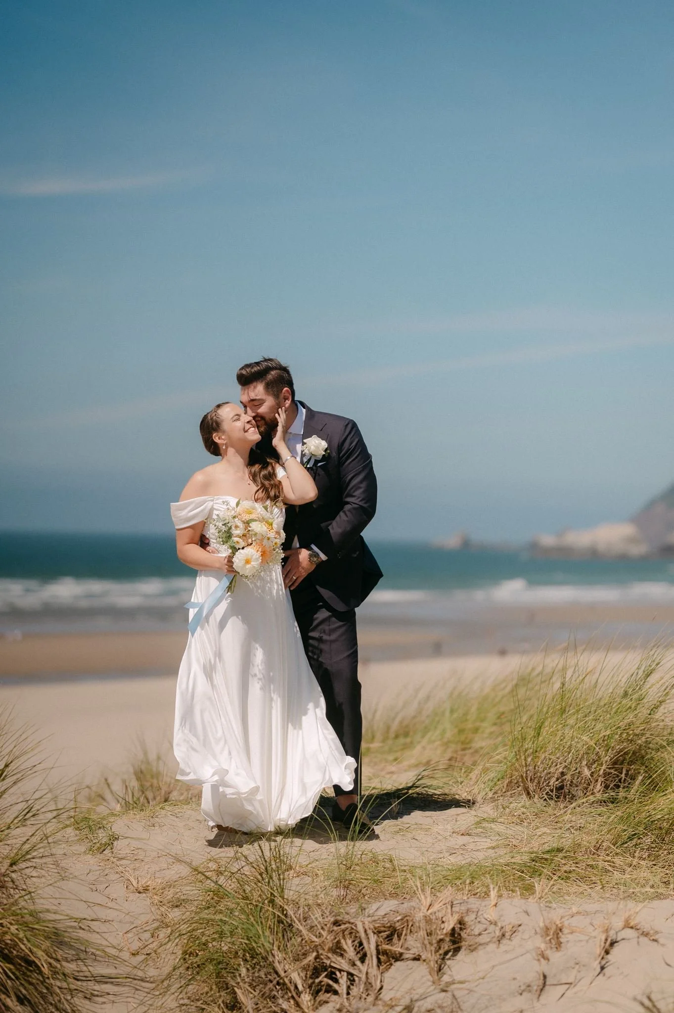 bride and groom at the beach during their cannon beach wedding on the oregon coast 