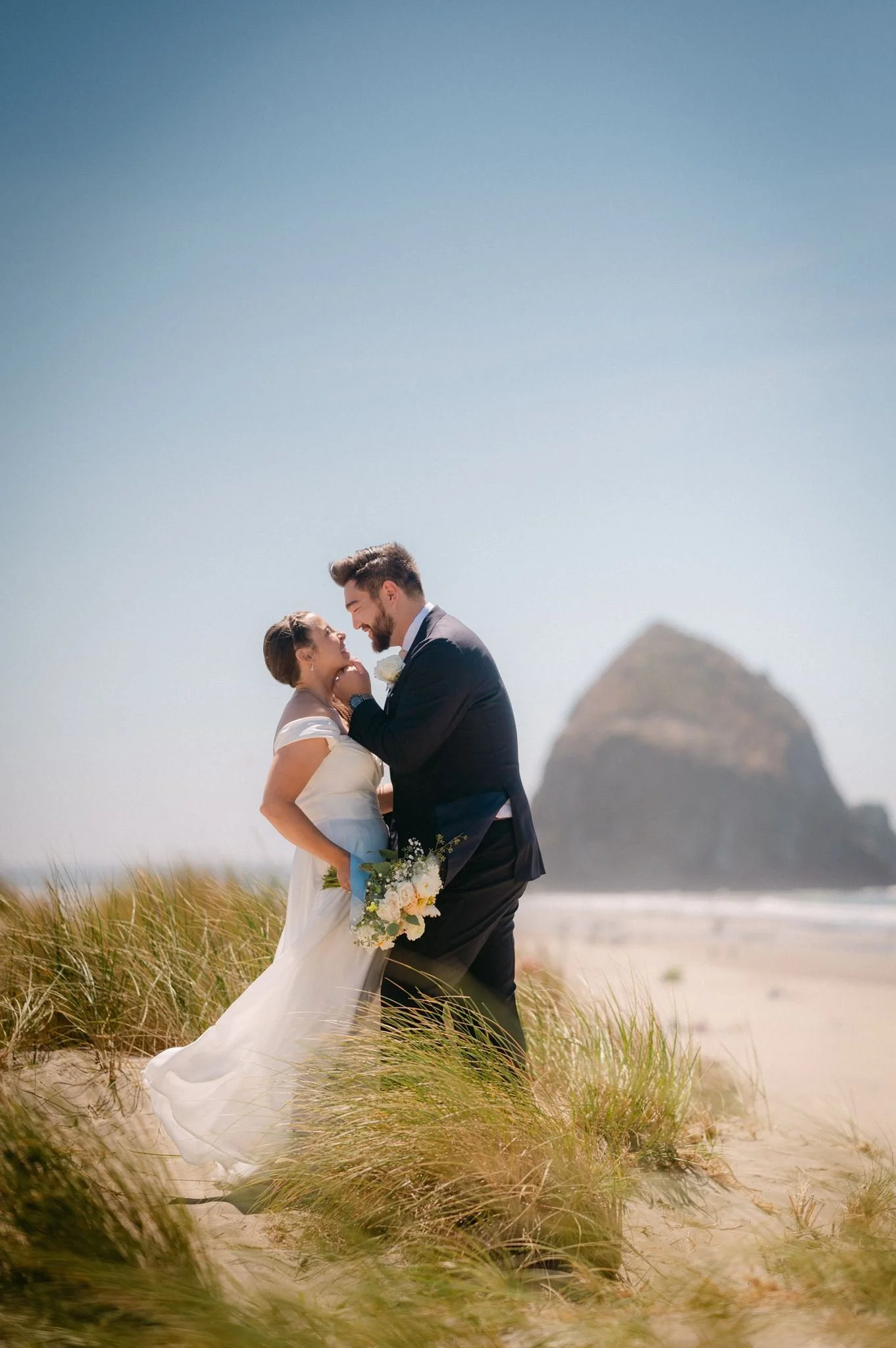 wedding couple at the beach during their cannon beach wedding on the oregon coast