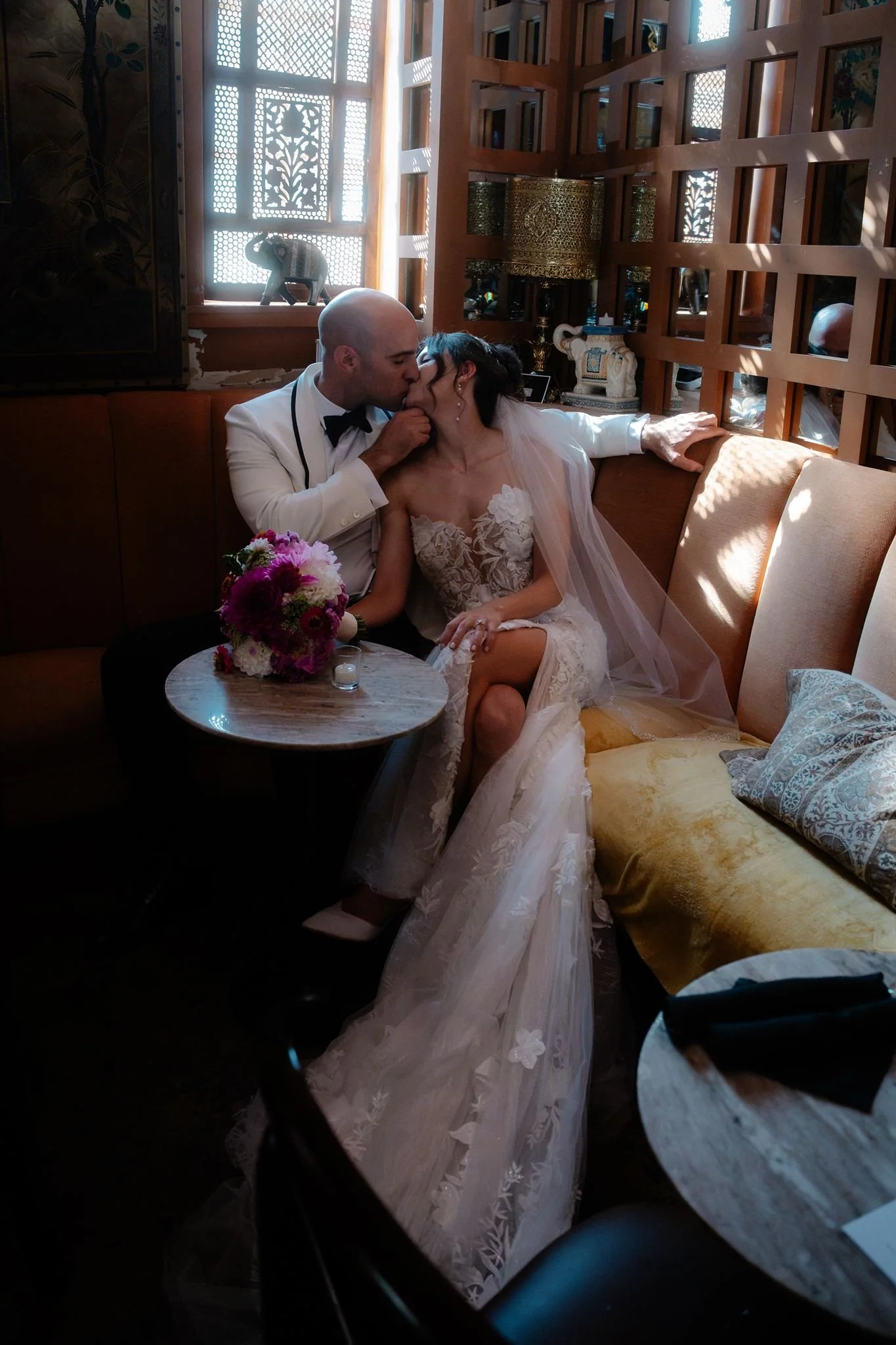 wedding couple kissing on a sofa during their quirky wedding day at the ruins in seattle 