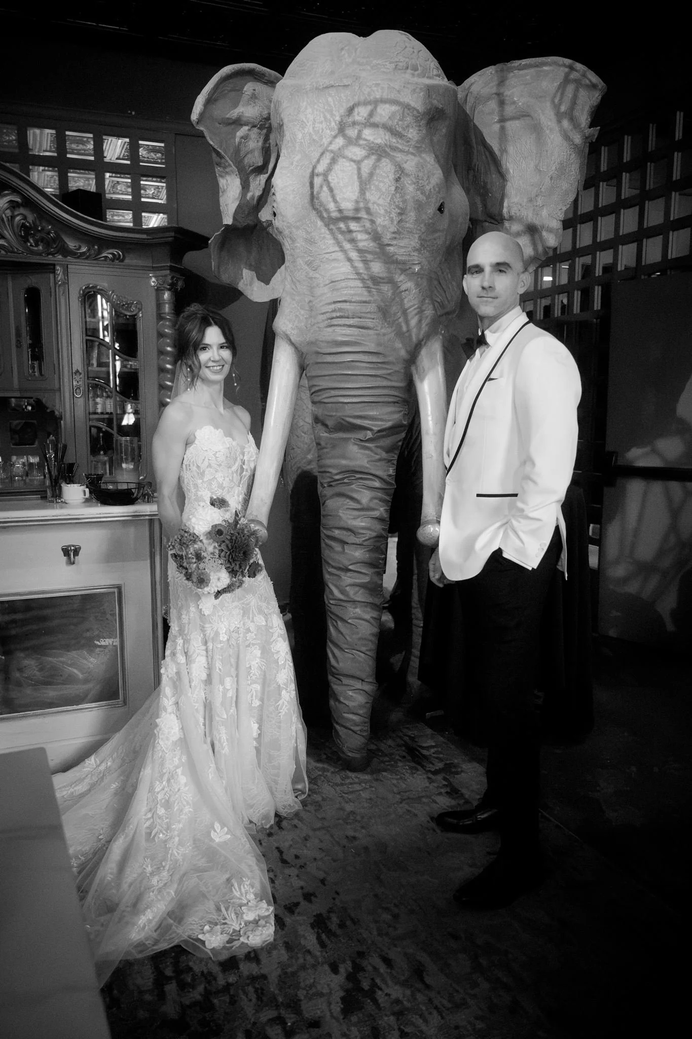 wedding couple with an elephant statue during their portraits at the ruins, seattle