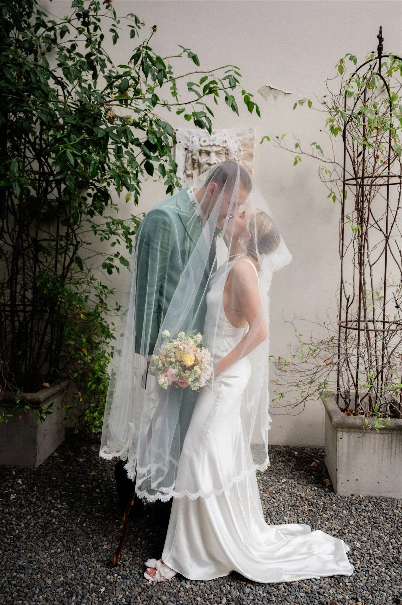couple kissing under a veil at the hall at fauntleroy in seattle washington