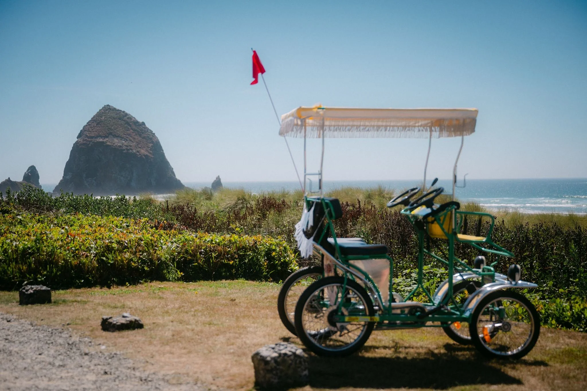 surrey bike with haystack rock in the background