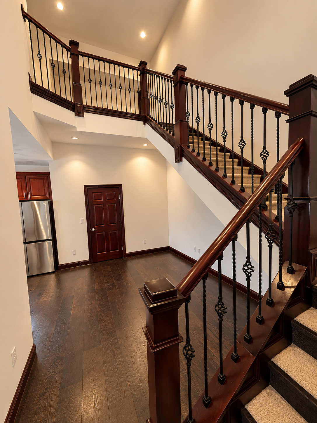 Warm Modern Foyer with Ornate Staircase.png