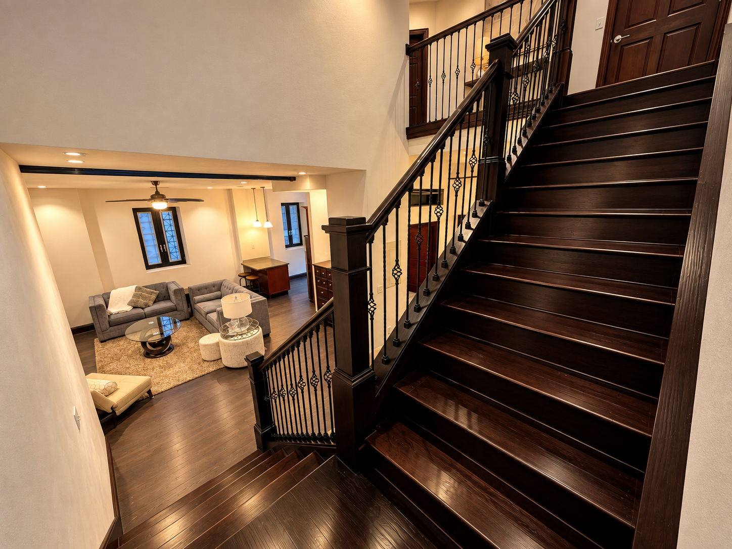 Warmly Lit Espresso Staircase Living Room.png