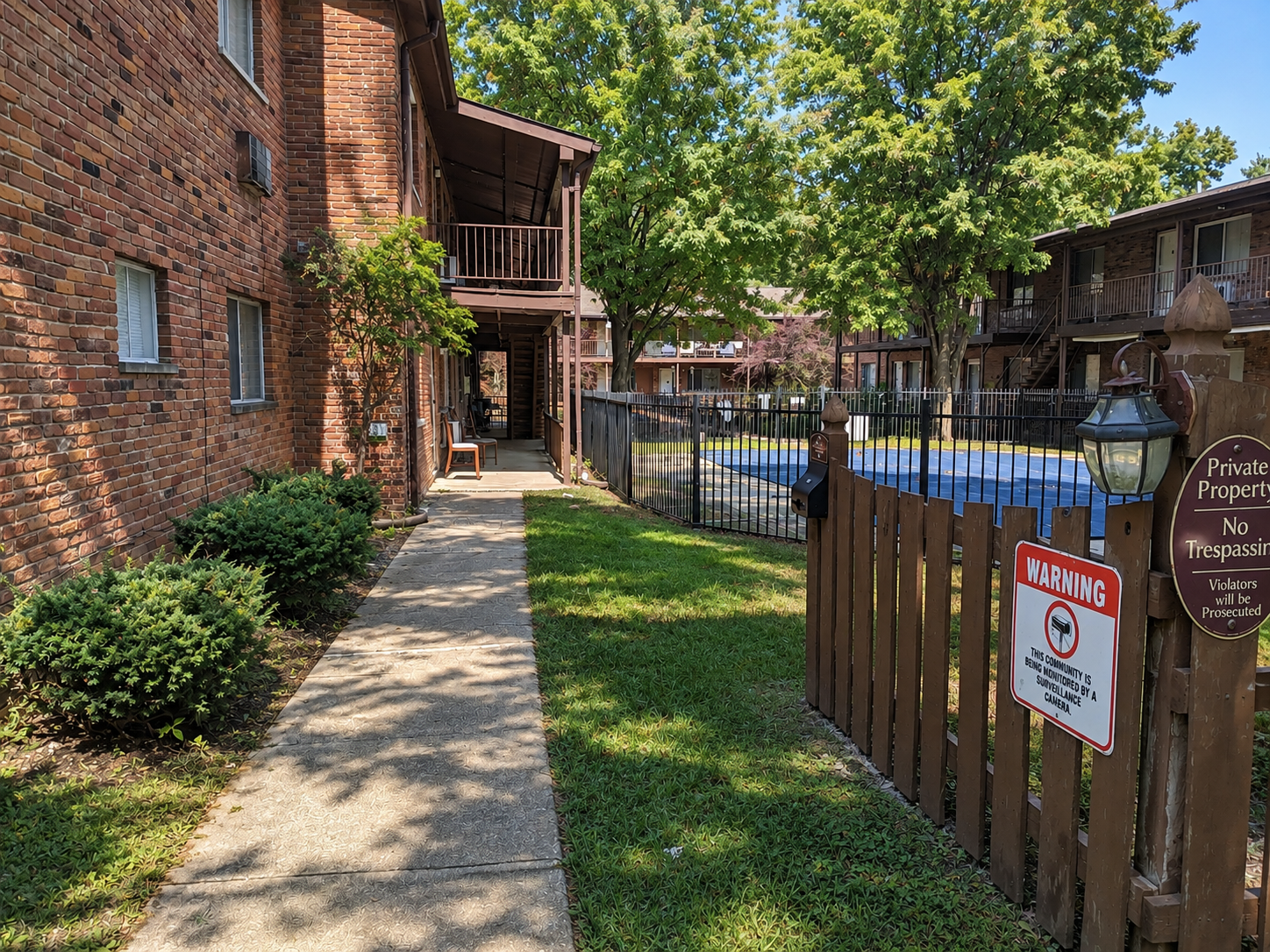 Sunlit Apartment Courtyard and Pool Fence.png