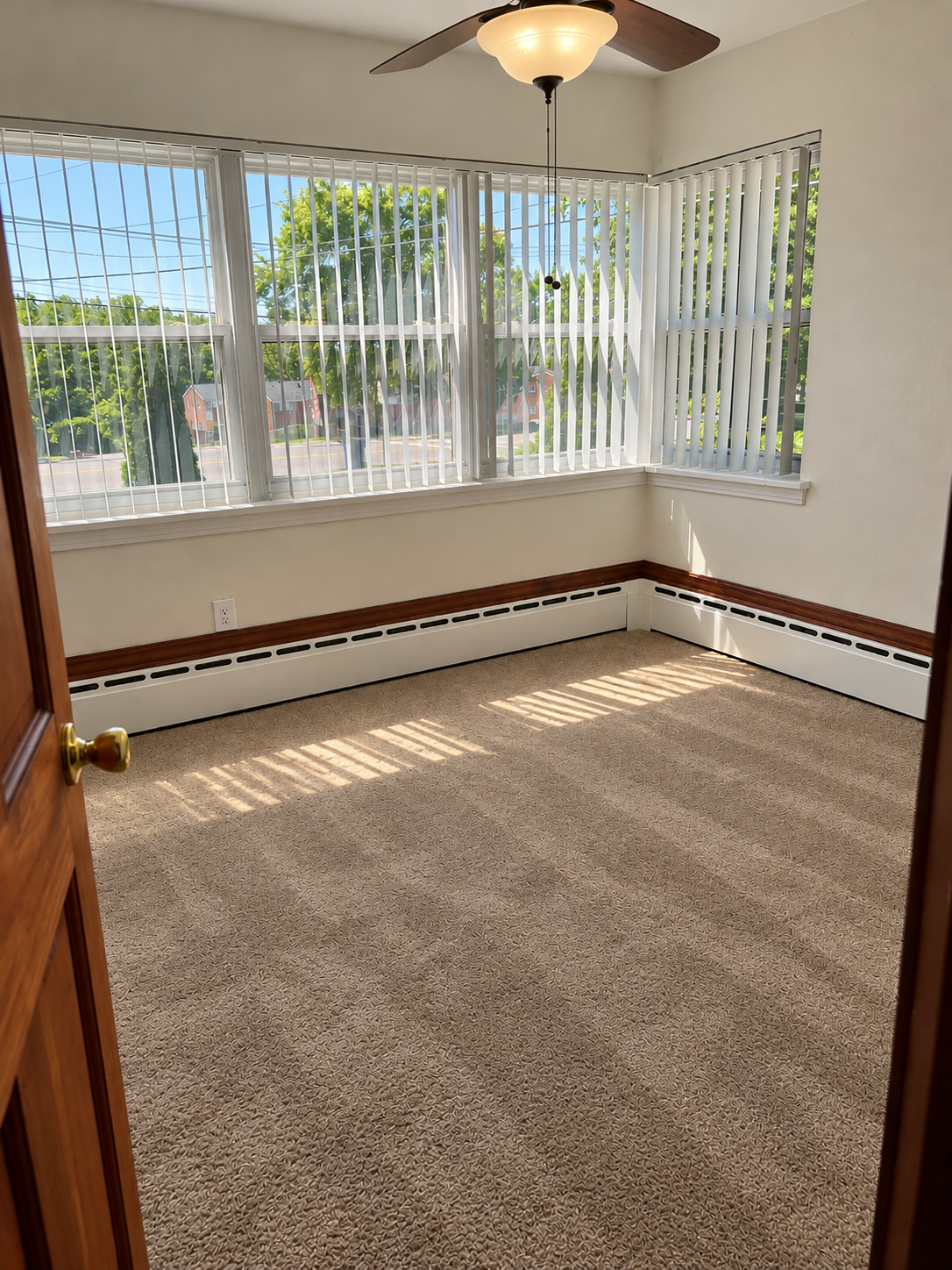 Sunlit Empty Room with Corner Windows.png