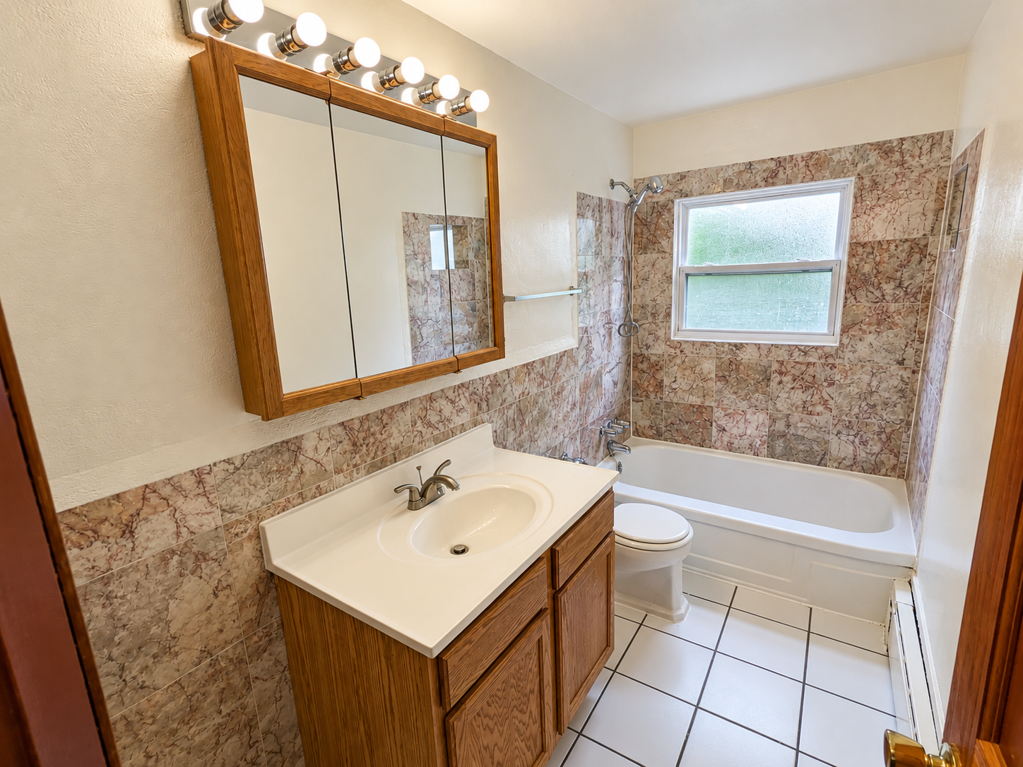 Warmly Lit Marble-Tile Bathroom.png