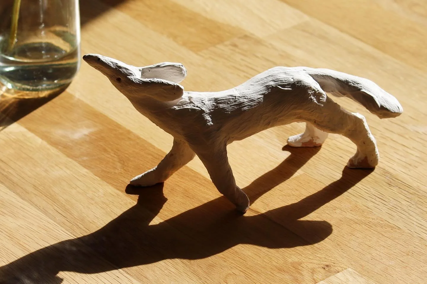 Earthenware miniature with brushed on white slip.