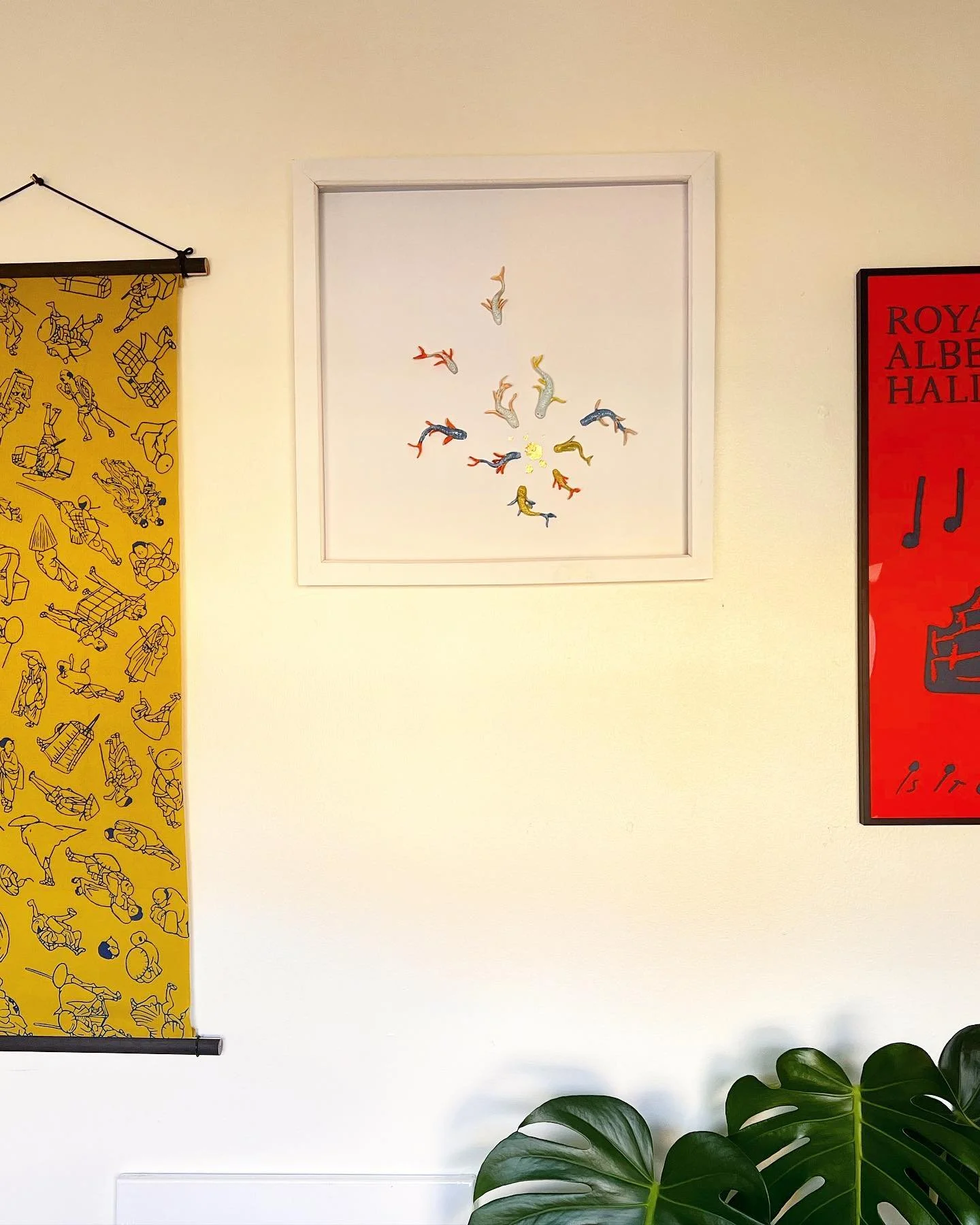 Pisces, tiny ceramic fish on paper.