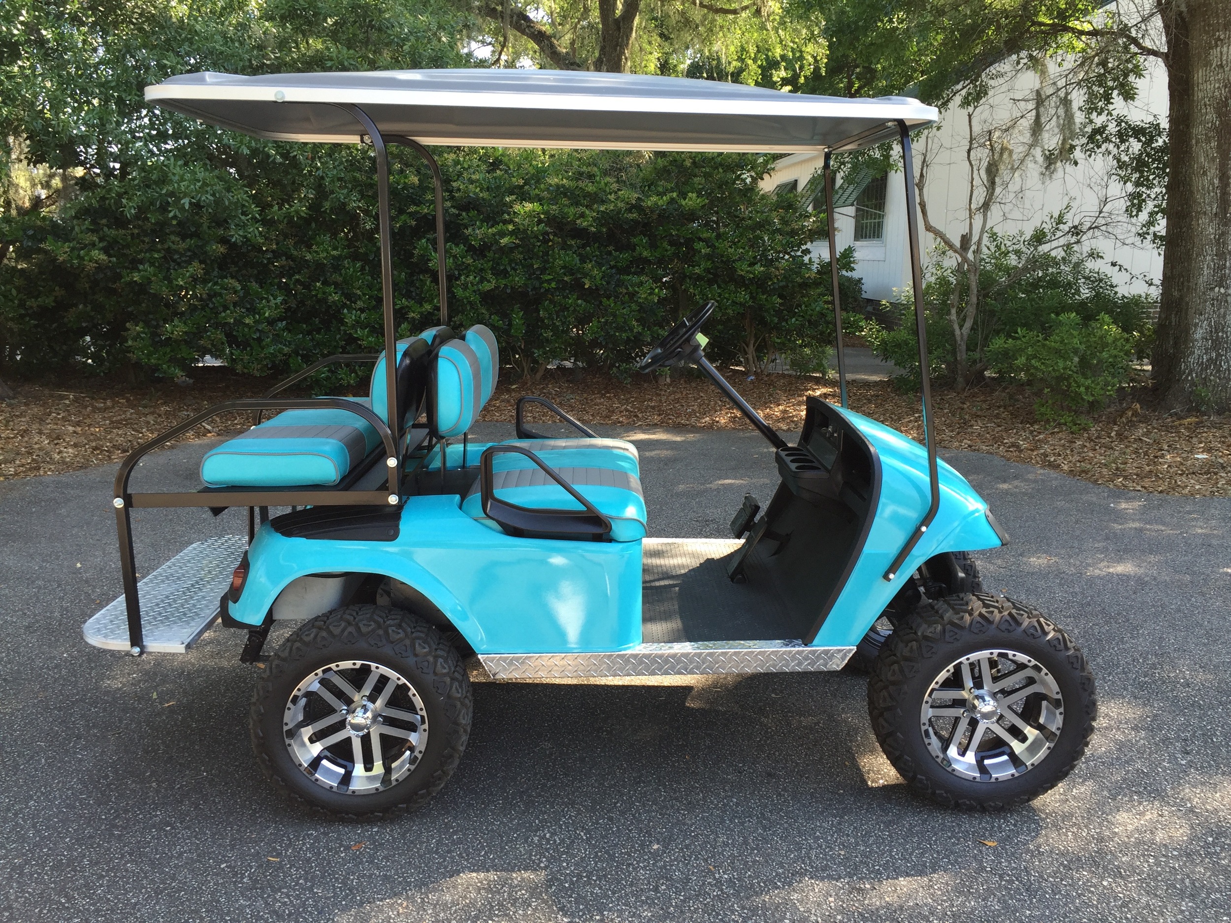 Aqua EZGO Lifted Cart Aqua/smoke seats, gray extended top, new batteries, LED lights, Backlash (23x10x14) tires, high speed code, mirror, flip windshield and state of charge meter