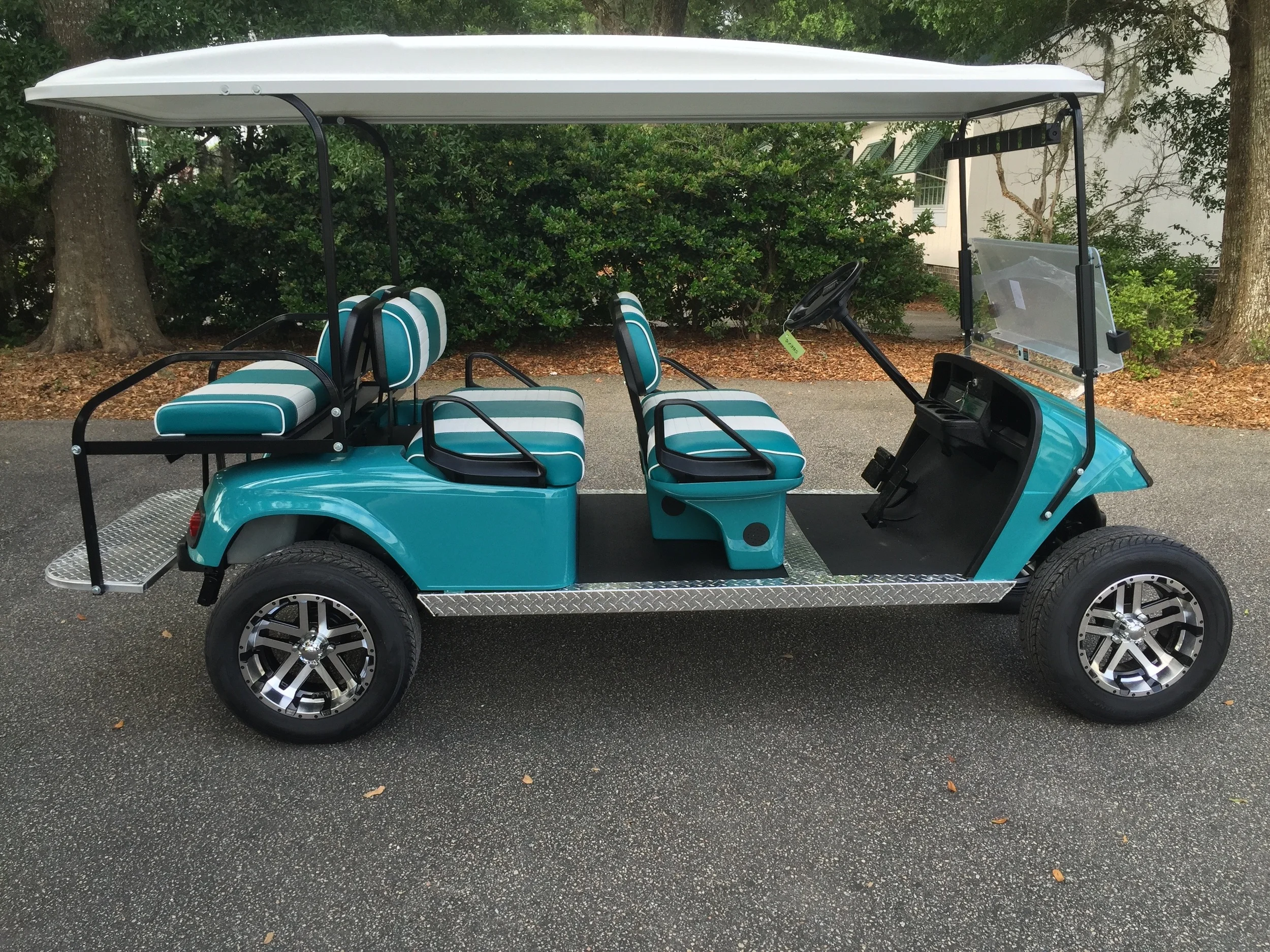 Teal EZGO Lifted Trolley Teal/white seats, white top, new 2018 (6-8vt) batteries, high speed code, LED lights, Backlash (23x10x14) tires, state of charge meter, mirror, and flip windshield
