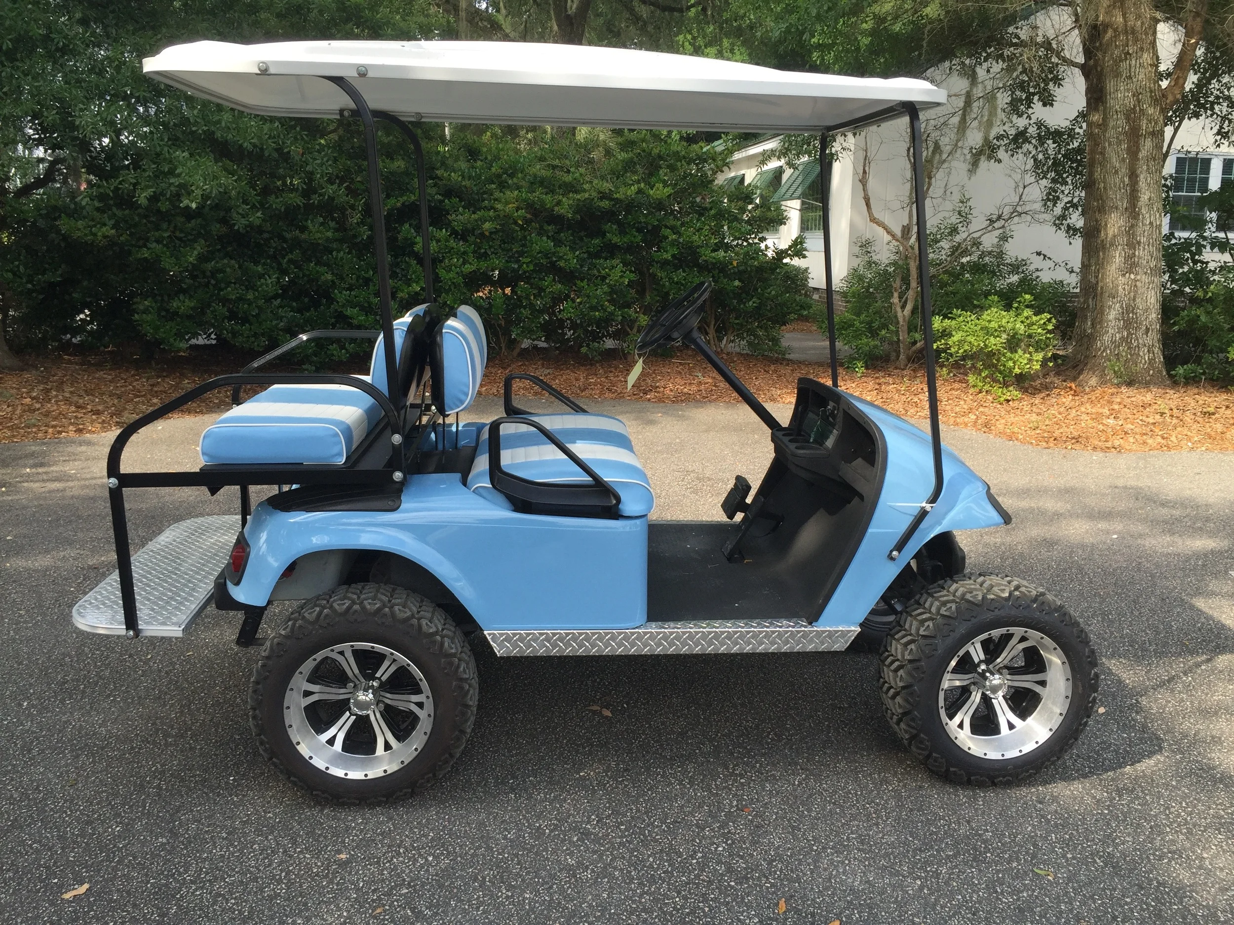 Lt. Blue EZGO Lifted Cart Lt. blue/white seats, white extended top, new batteries, high speed code, LED lights, Backlash (23x10x14) tires, mirror, flip windshield, and state of charge meter