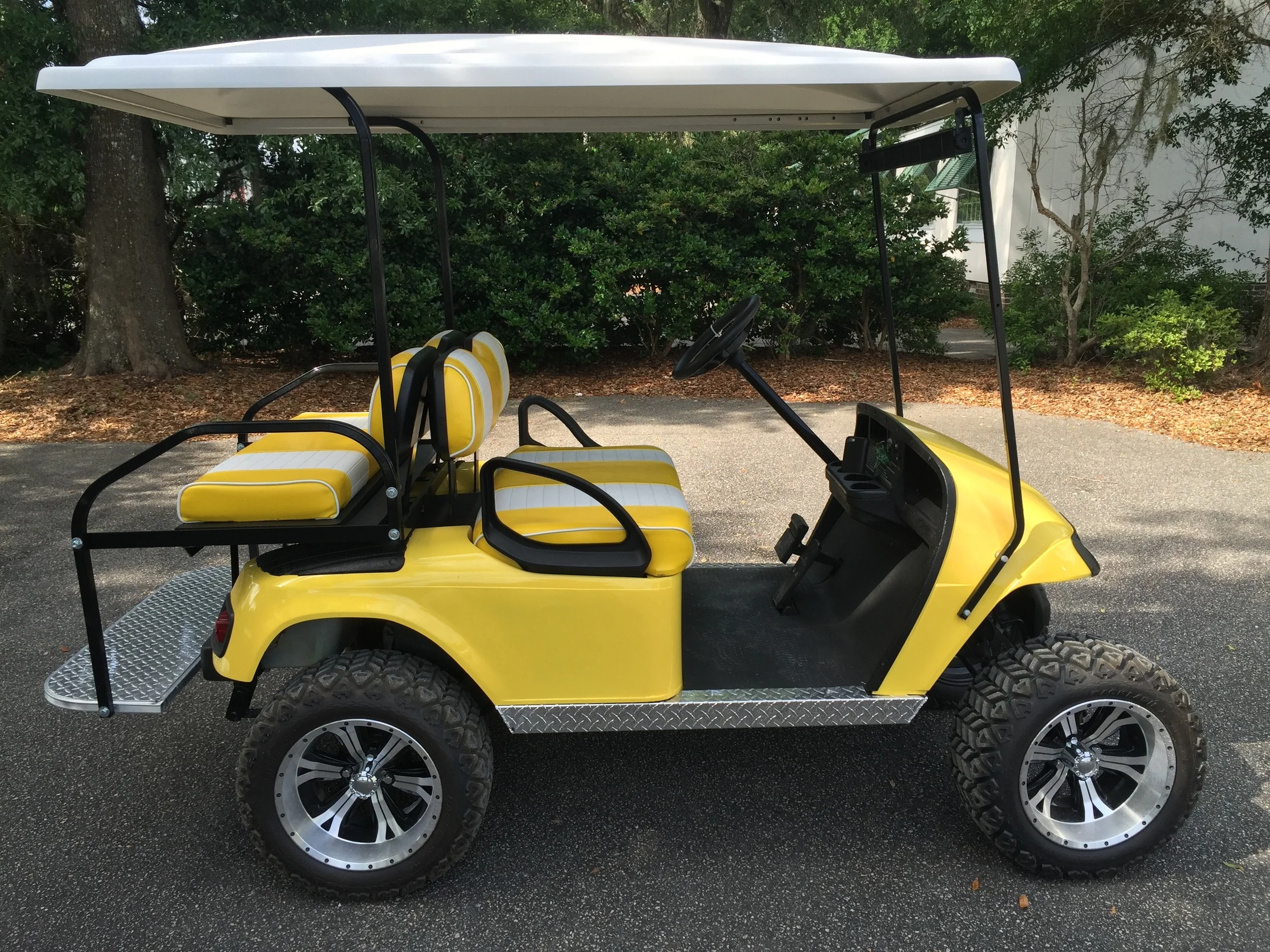 Yellow EZGO Lifted Cart Yellow/white seats, white extended top, new (2017) batteries, high speed code, LED lights, Backlash (23x10x14) tires, mirror, flip windshield, and state of charge meter