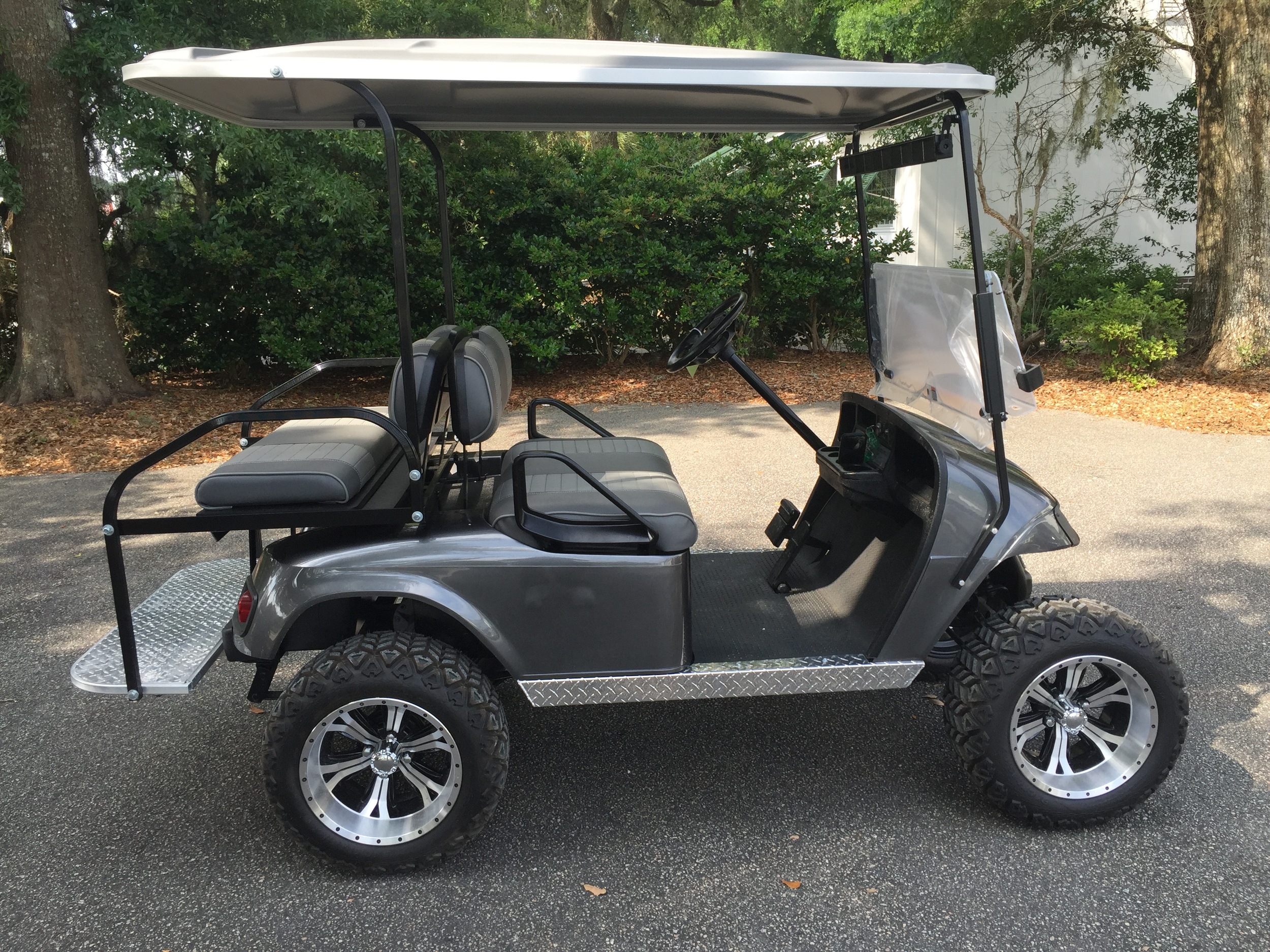 2015 Charcoal EZGO Lifted Cart ———In Stock Charcoal/smoke seats, gray extended top, new 2019 batteries 48vt (6-8), high speed code, state of charge meter, LED lights, Backlash (23x10x14) tires, mirror, and flip windshield