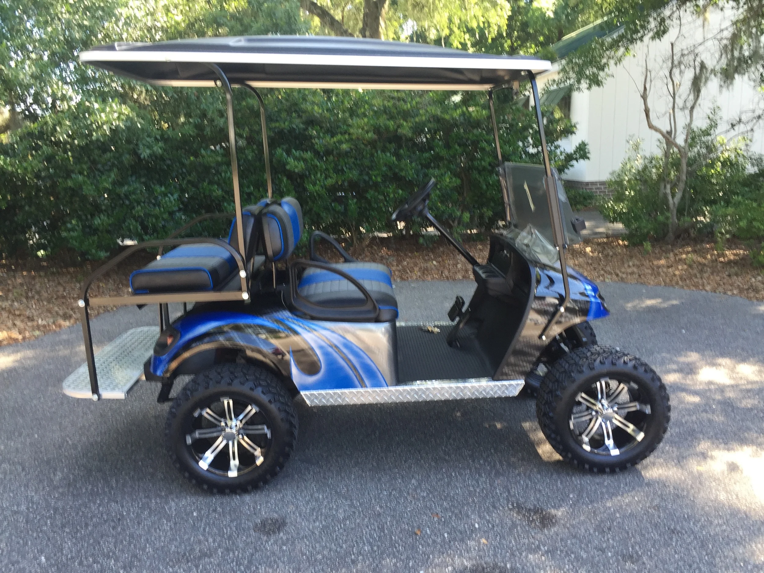 Viper Blue Swirl EZGO Lifted Cart Viper blue/charcoal/black seats, black extended top, new batteries, high speed code, LED lights, Backlash (23x10x14) tires, mirror, flip windshield, and state of charge meter