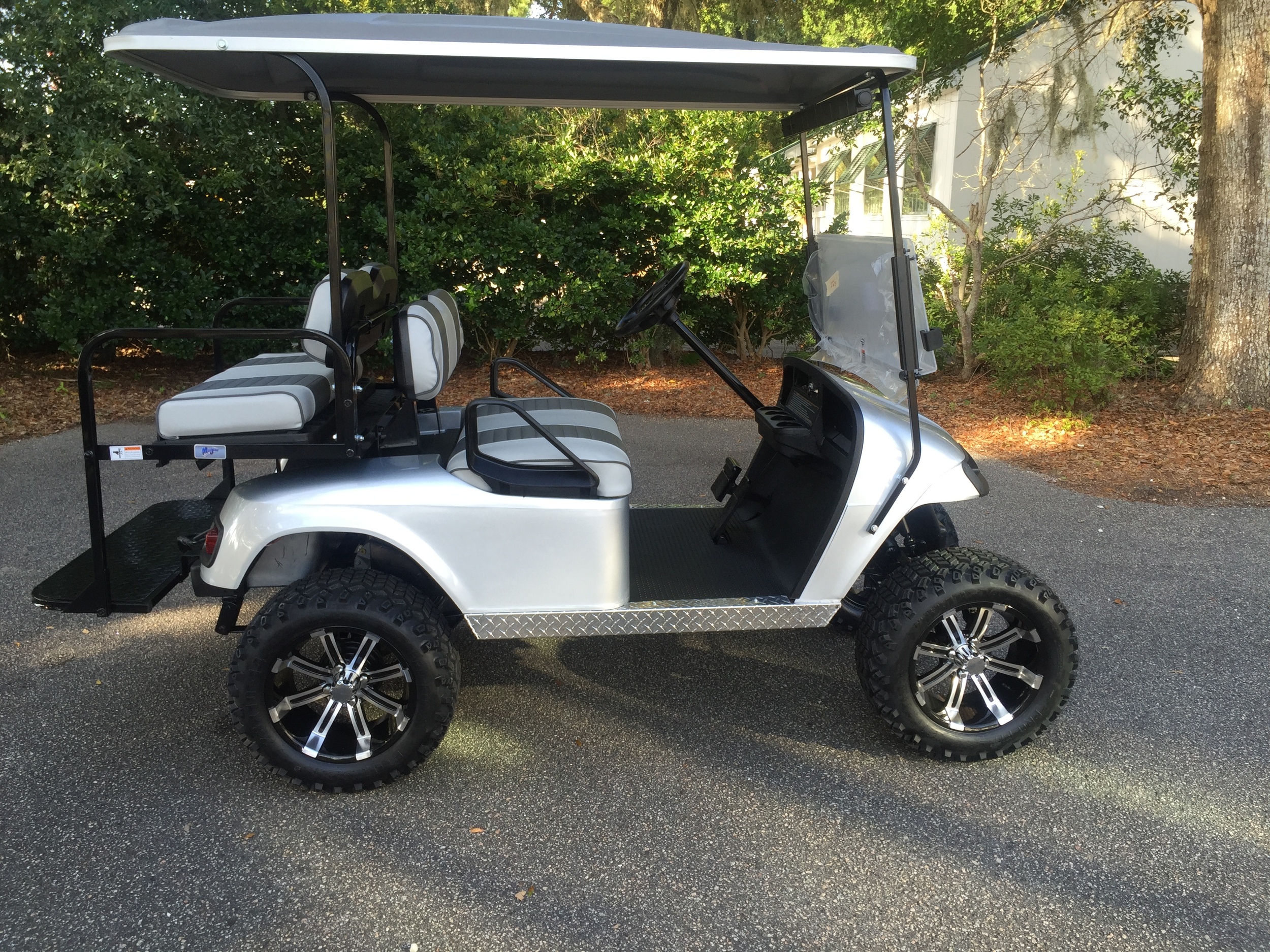 Silver EZGO Lifted Cart Gray/charcoal seats, gray extended top, new 2018 batteries, high speed code, LED lights, Backlash (23x10x14) tires, mirror, flip windshield, and state of charge meter